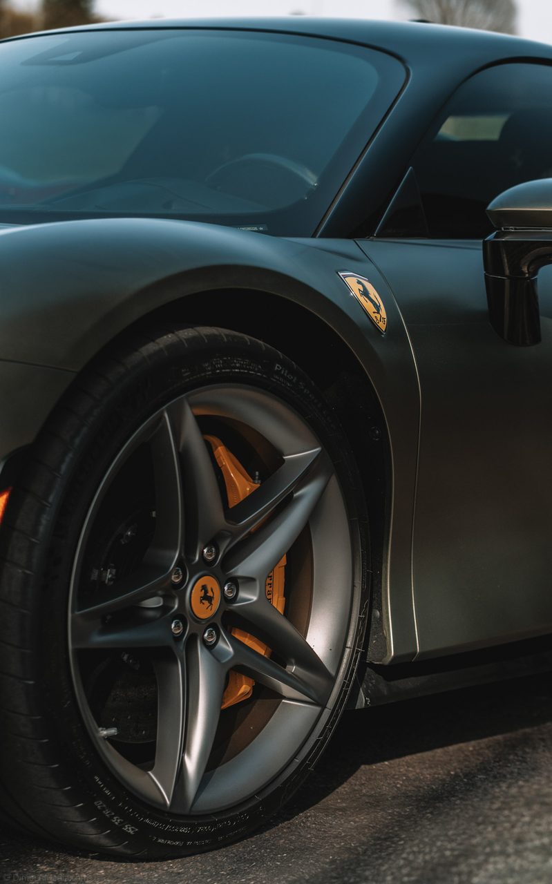 Forged wheel and yellow caliper detail on a matte Ferrari