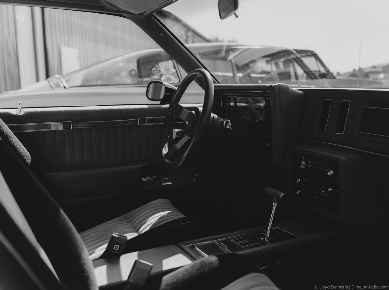 Black and white interior of a Buick Grand National with column shifter
