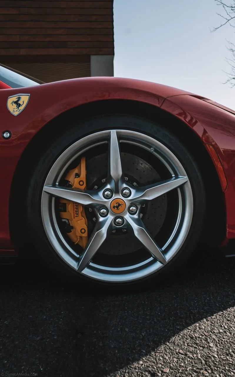 Matte grey Ferrari SF90 beneath a country club crest