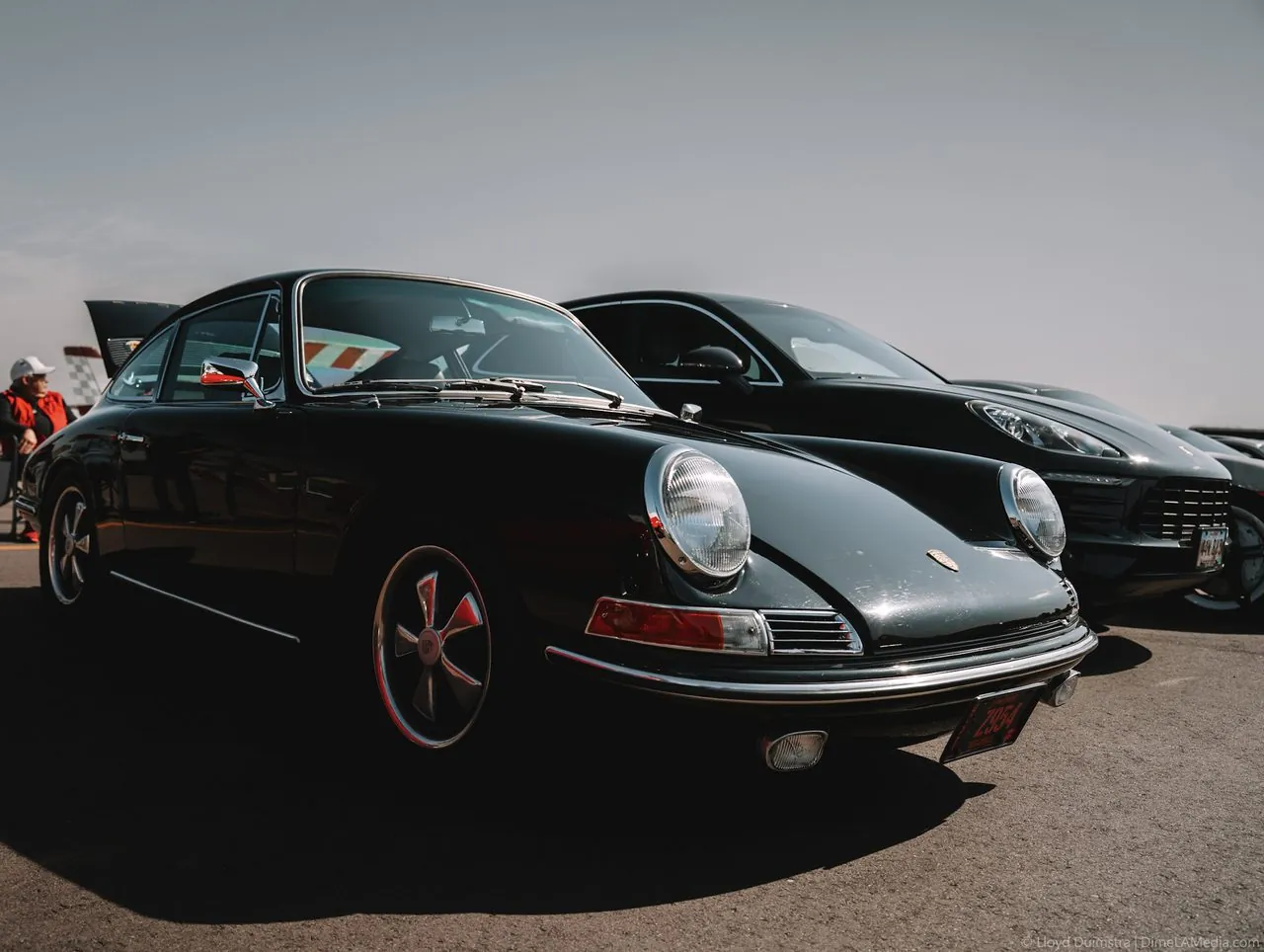 Vintage Porsche 911 in dark green parked at a track day
