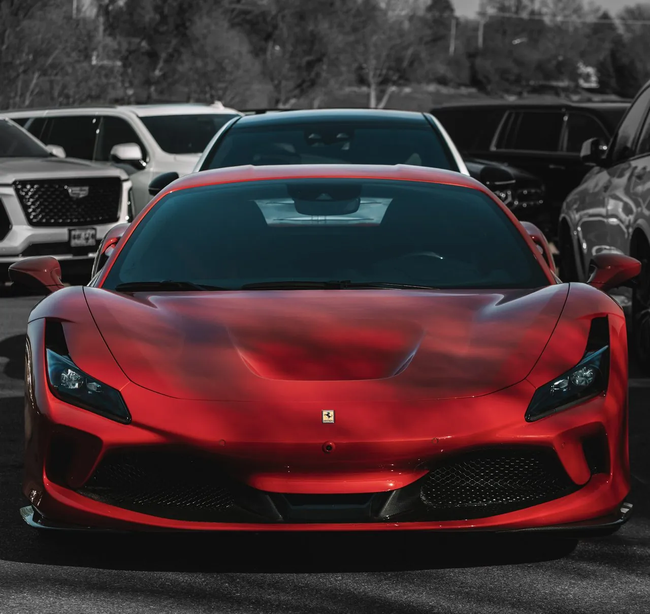 Red Ferrari F8 photographed head-on in a parking lot
