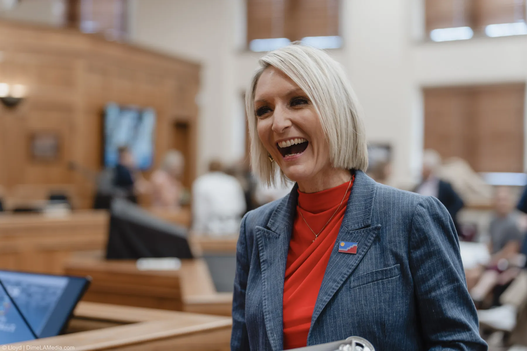 Christine Erickson laughs with guests in the chamber before the swearing-in ceremony