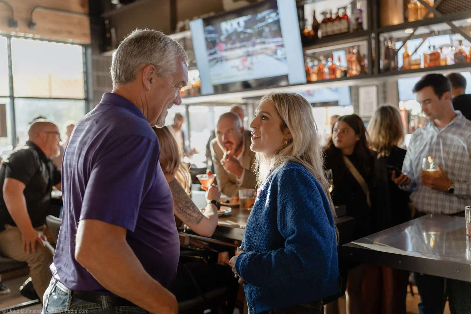 Guests share a table in evening light at the election night watch party in Sioux Falls South Dakota
