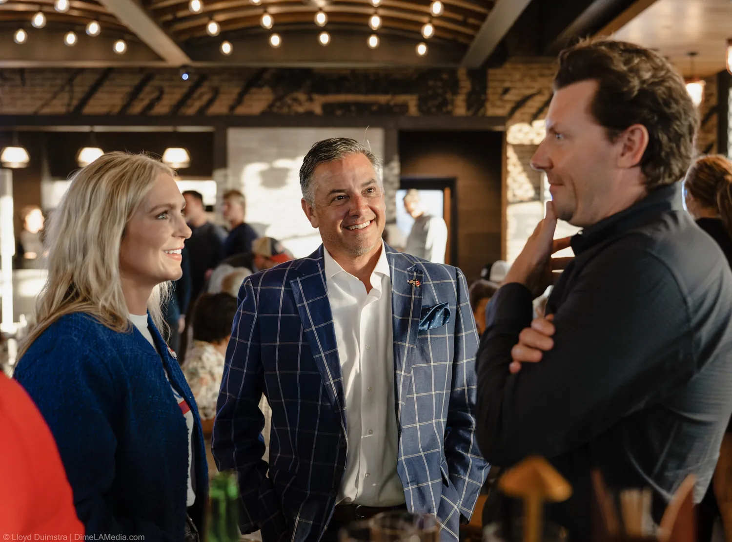Christine Erickson shares a laugh with two supporters at the election night party