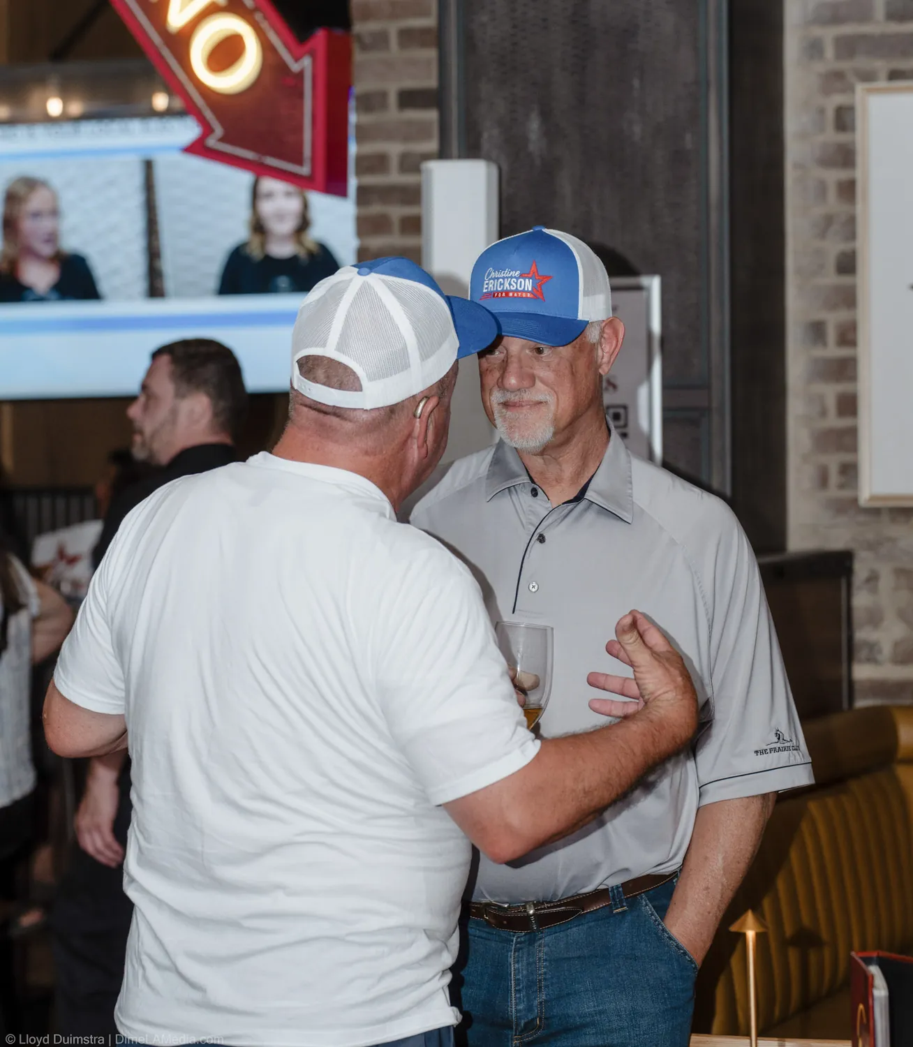 Two supporters embrace at the Christine Erickson watch party