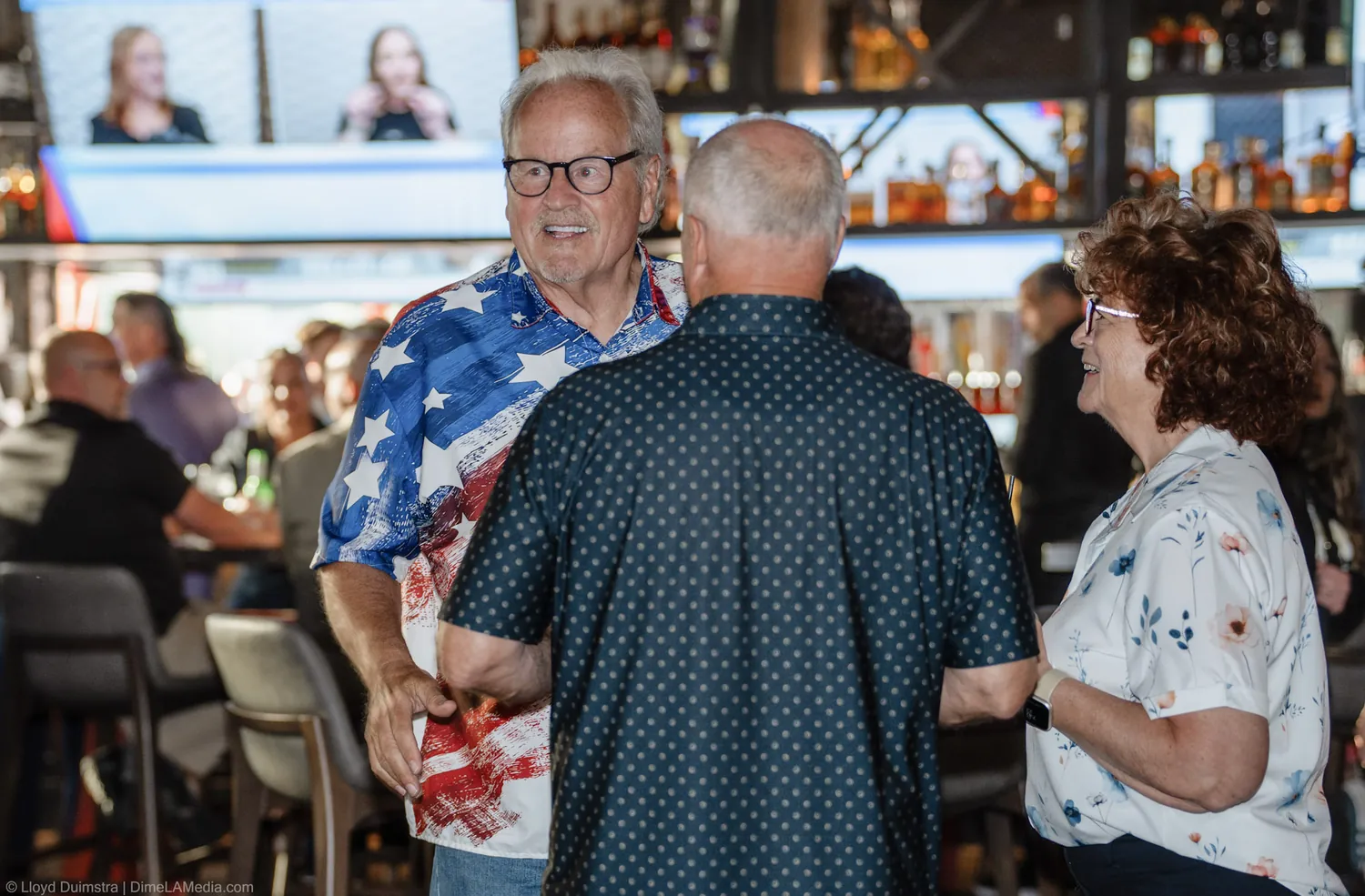 Supporters greet each other in warm light at the election night party in Sioux Falls