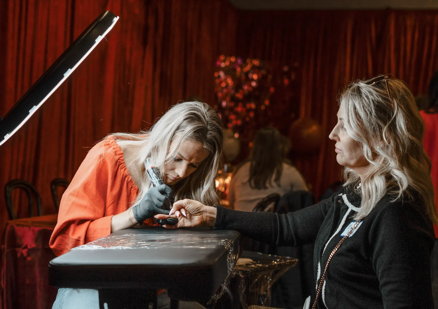 A guest gets a hand-poked design at a Christine Erickson community event in Sioux Falls