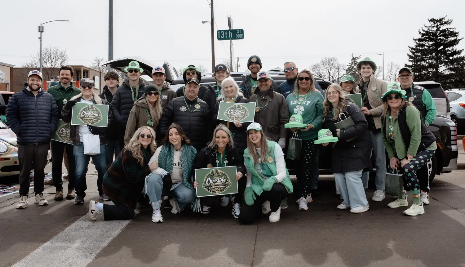The Christine Erickson campaign team with green signs at the St. Patrick's Day parade in downtown Sioux Falls
