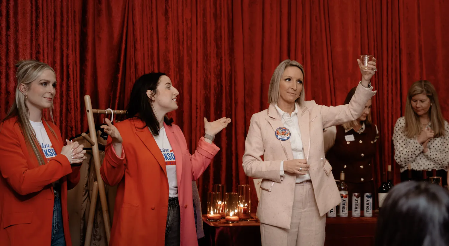 Guests visit at a community event hosted by the Christine Erickson campaign