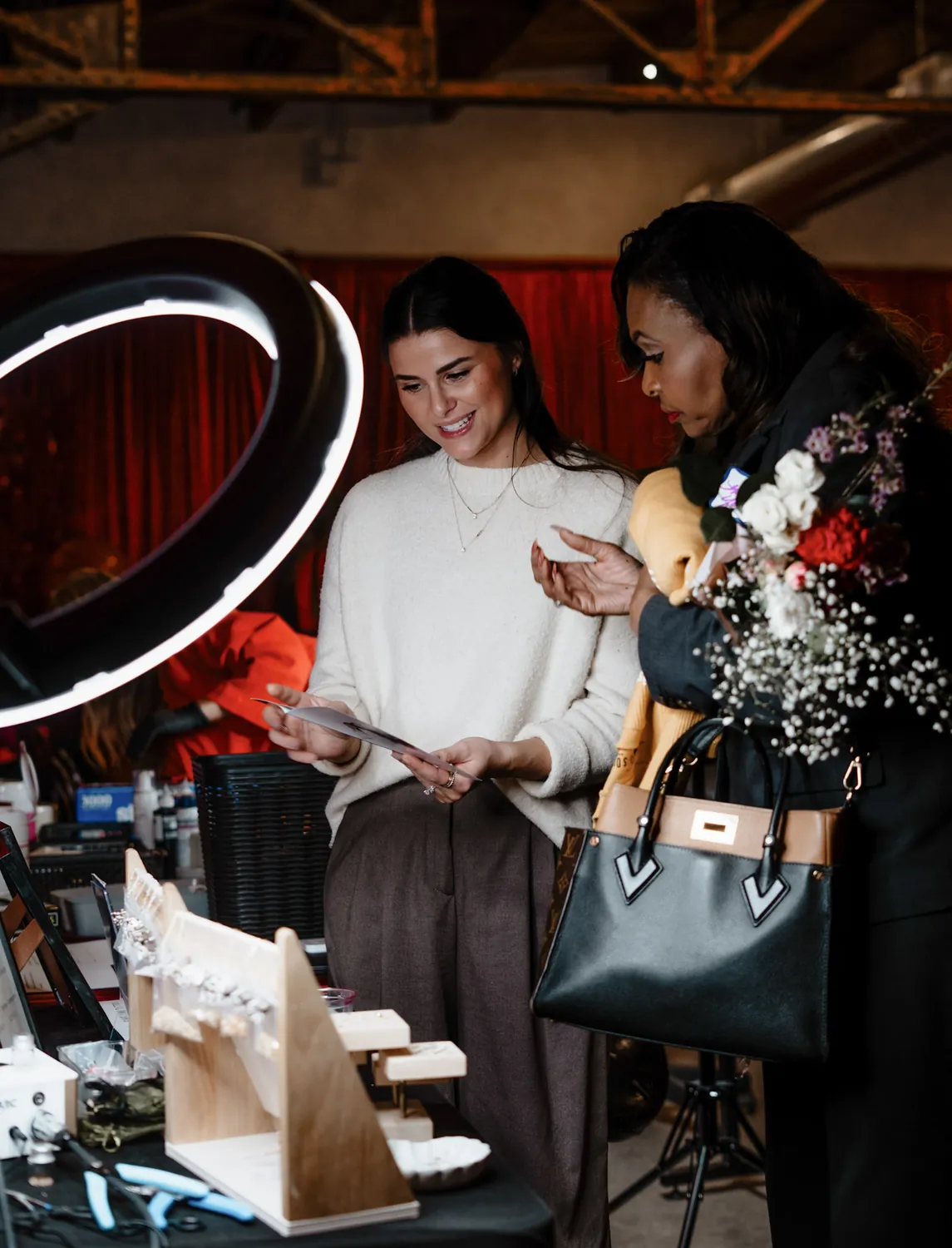 Guests browse a vendor table at a Christine Erickson community event