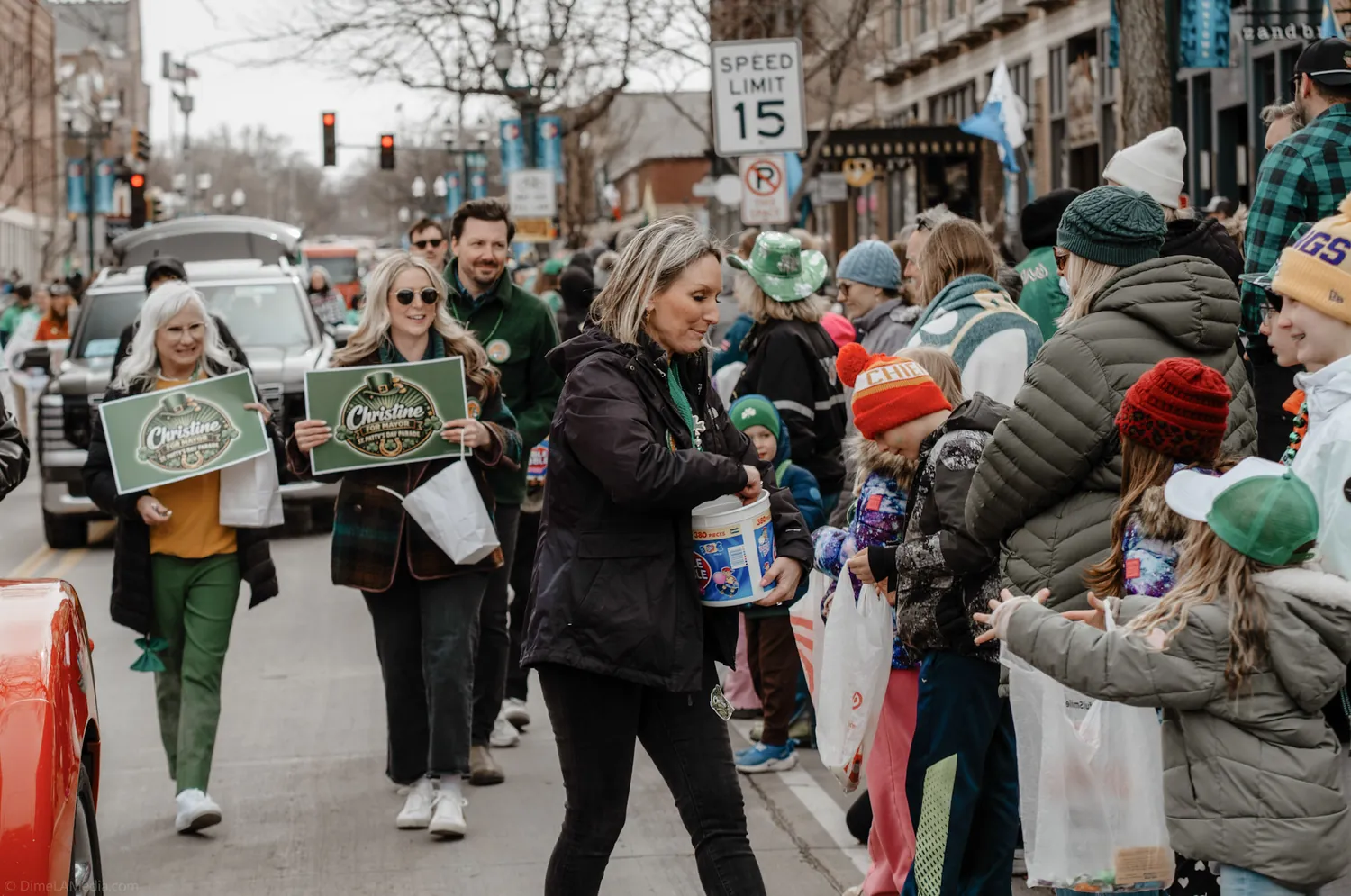 The campaign team hands out candy to kids along the St. Patrick's Day parade route in Sioux Falls
