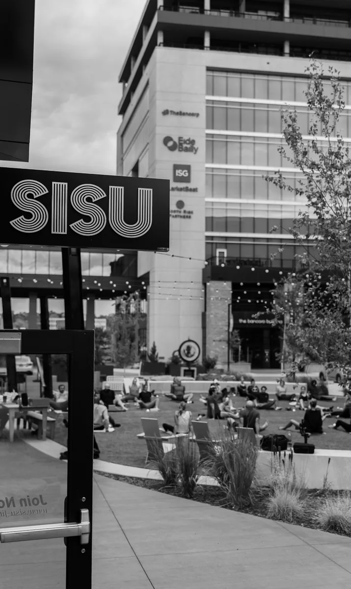The Sisu sign above the Cherapa Place lawn before the outdoor Kinstretch class, photographed by Lloyd Duimstra, downtown Sioux Falls SD