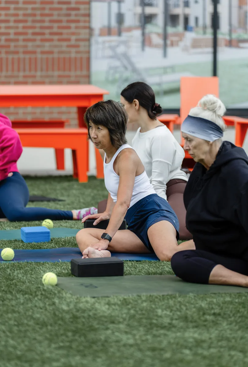 Outdoor Kinstretch class hosted by Sisu and Pomegranate Market, photographed by Lloyd Duimstra at Cherapa Place in downtown Sioux Falls SD