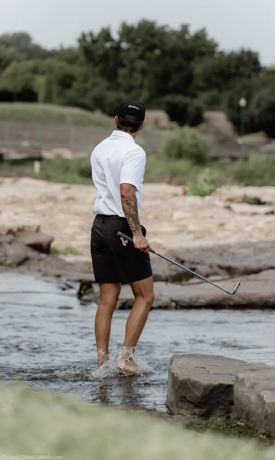 Peter Gotner plays a shot from the rocks along the Big Sioux River in Sioux Falls