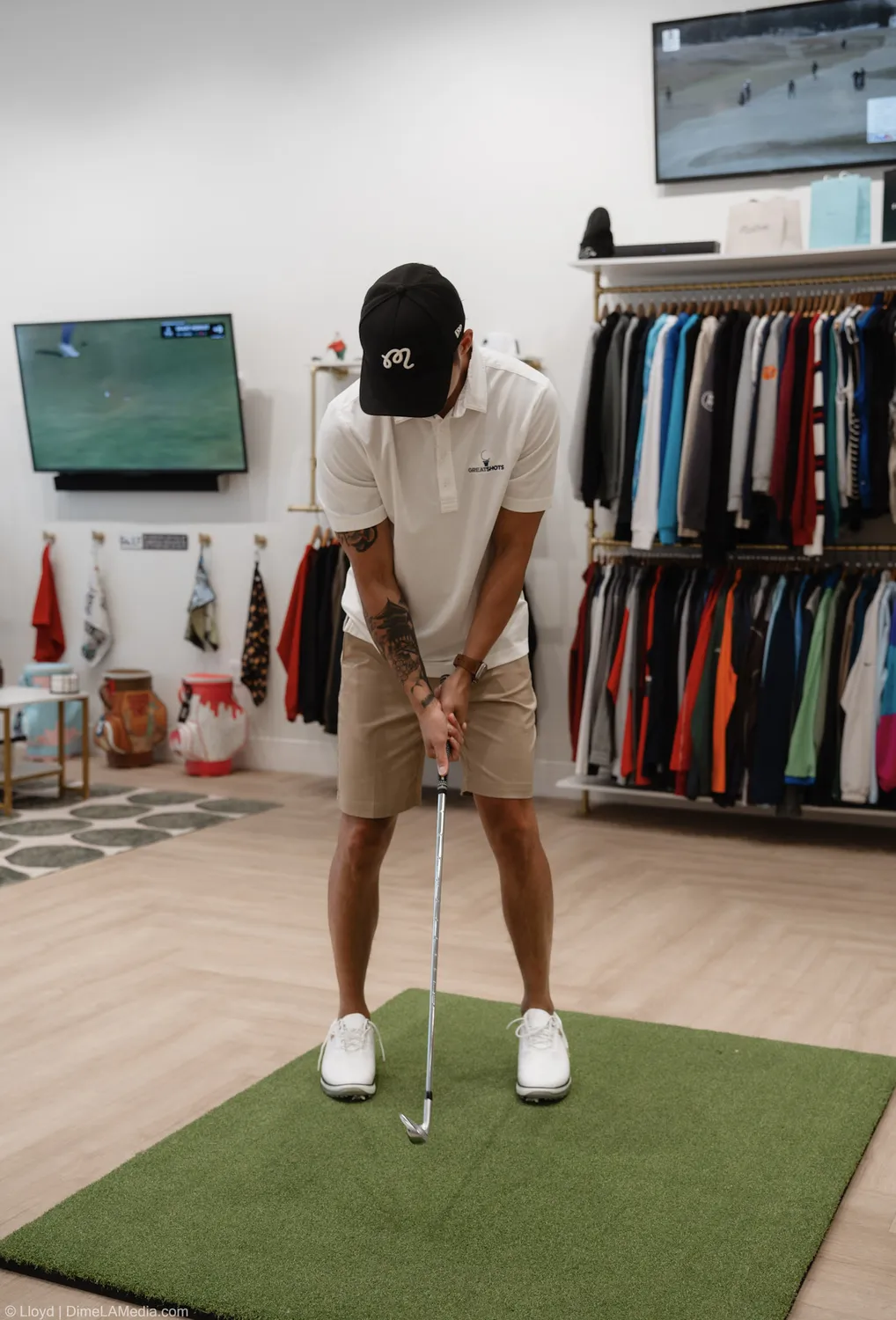 Peter Gotner putts on the practice green inside his Final Drive golf shop