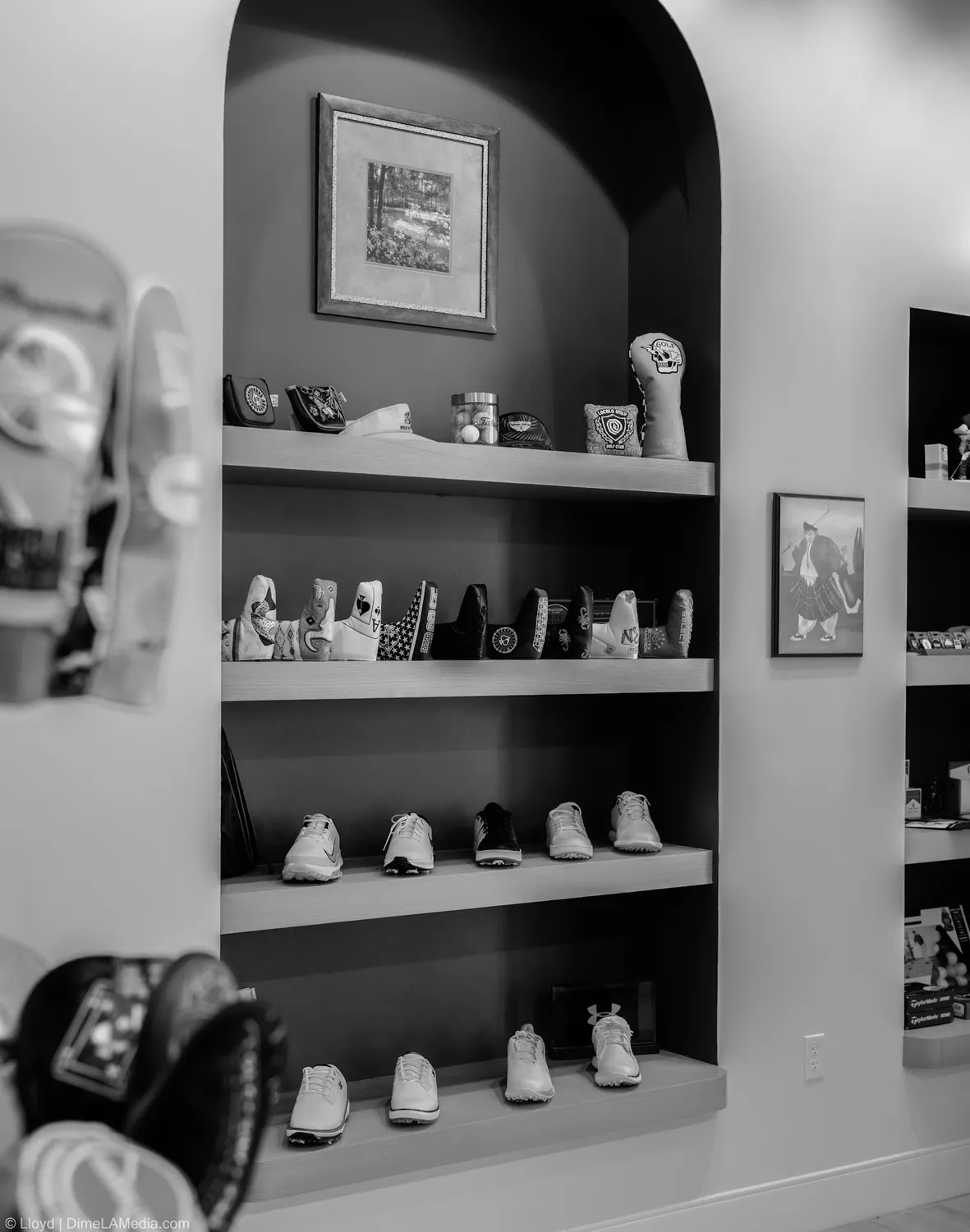 Black and white frame of headcovers and shoes on the shelves at Final Drive