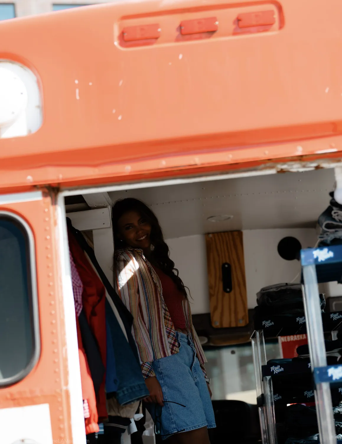 Browsing the racks of vintage clothing inside the True Vintage bus in Sioux Falls