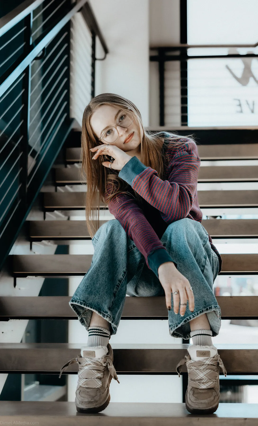 Syd Patzwald relaxed senior portrait on a modern staircase