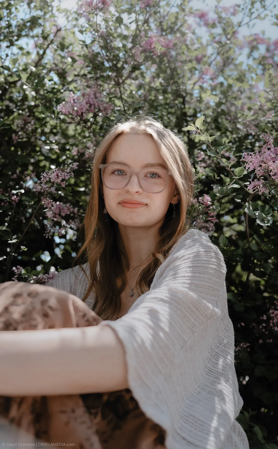 Syd Patzwald spring senior portrait in lilac blooms