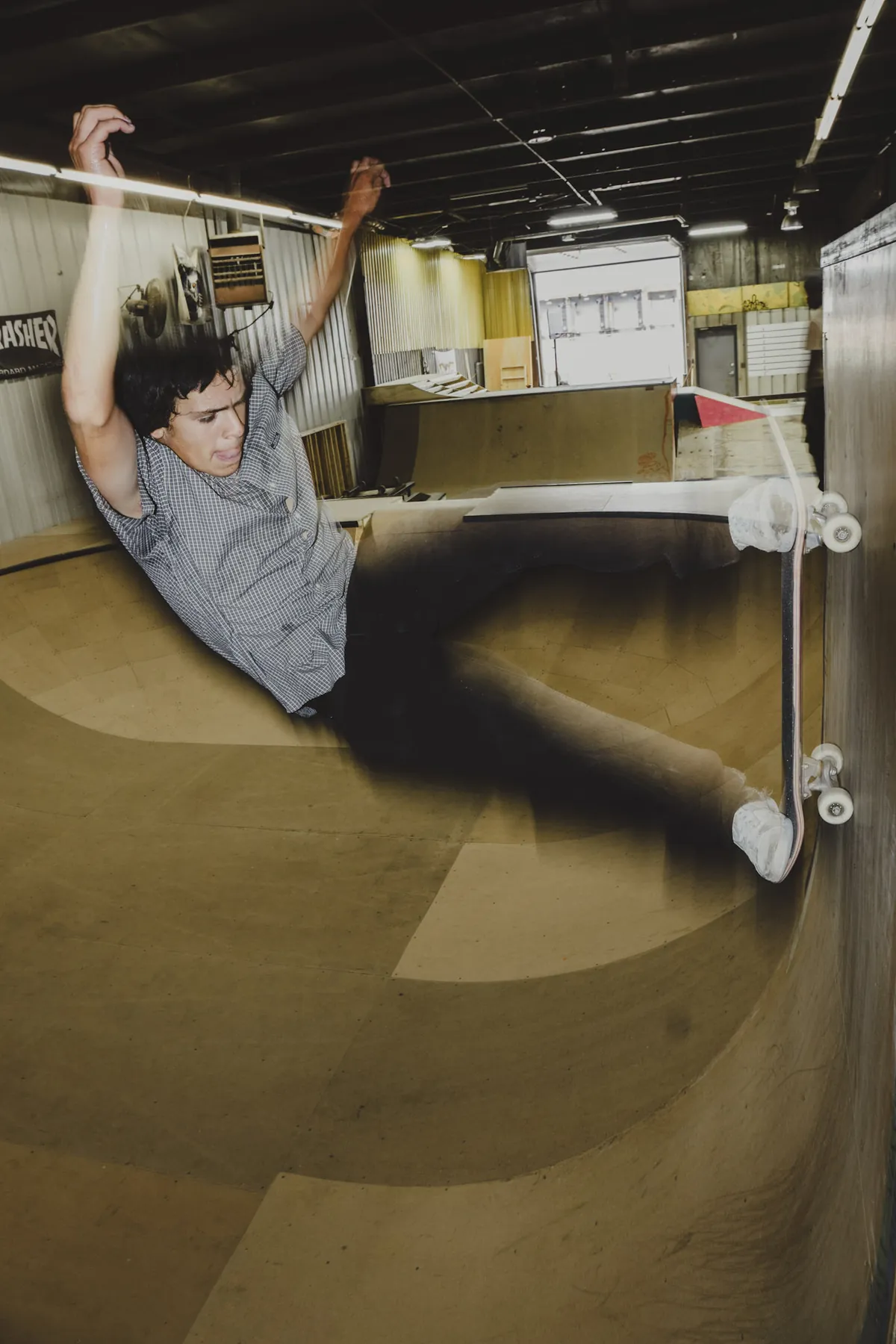 Skater flying the wall ride at an indoor skatepark