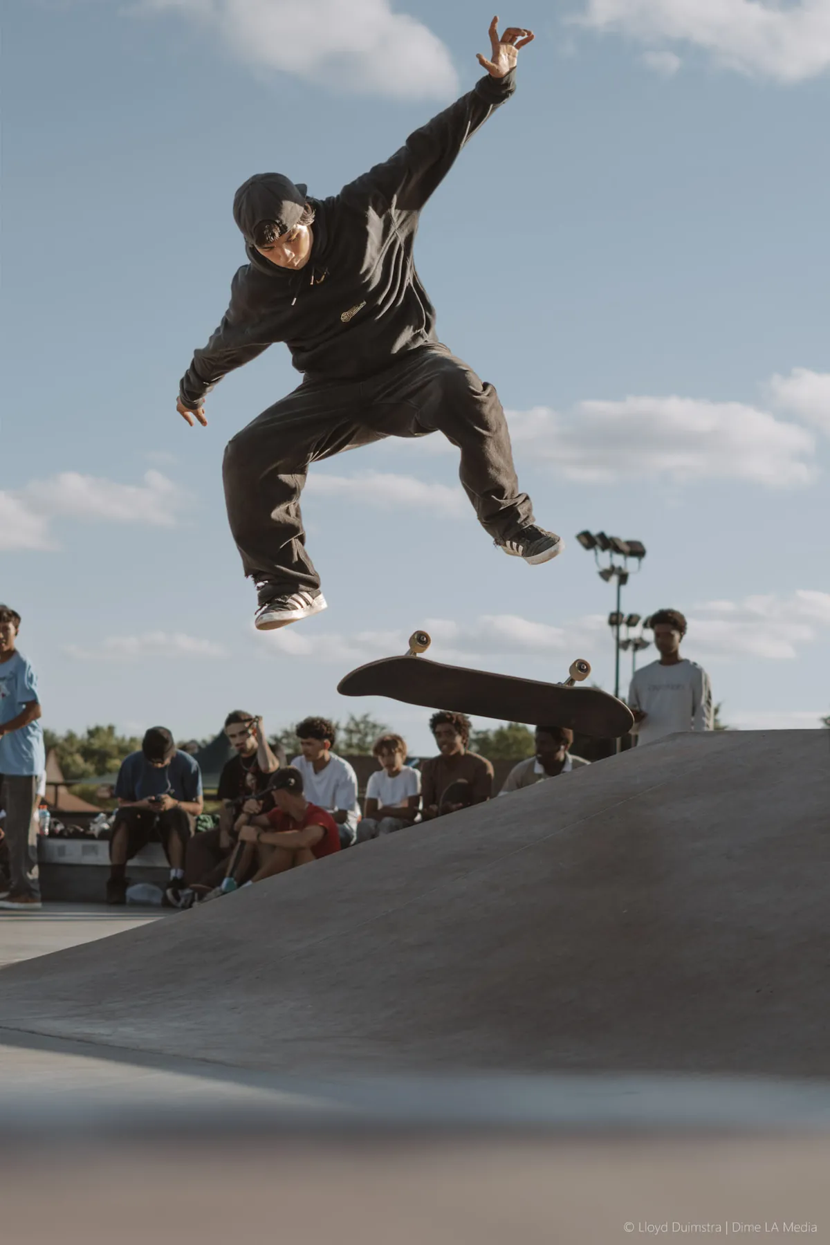 Skateboarder threading a line through the park