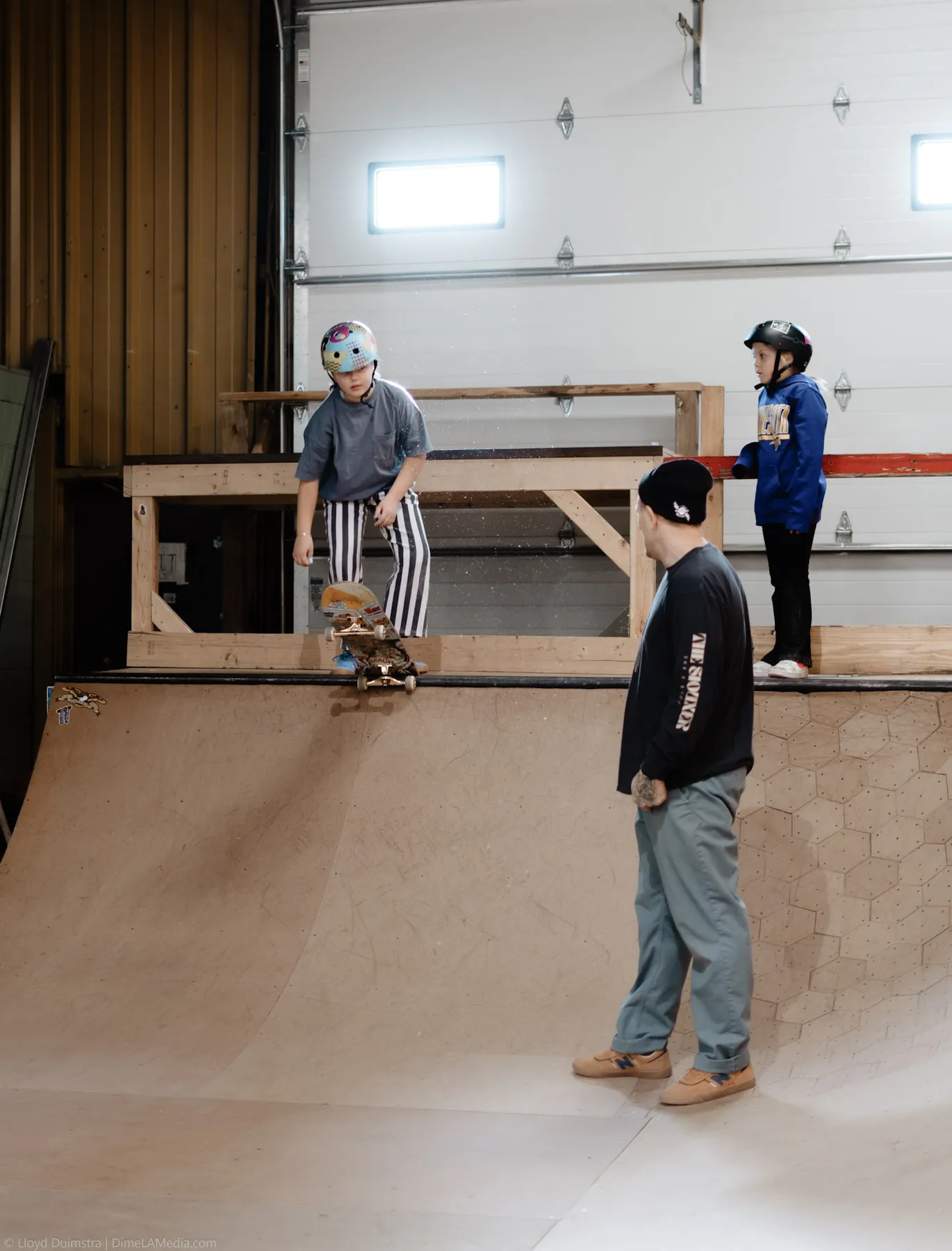 Young skaters working the ramps at an indoor session
