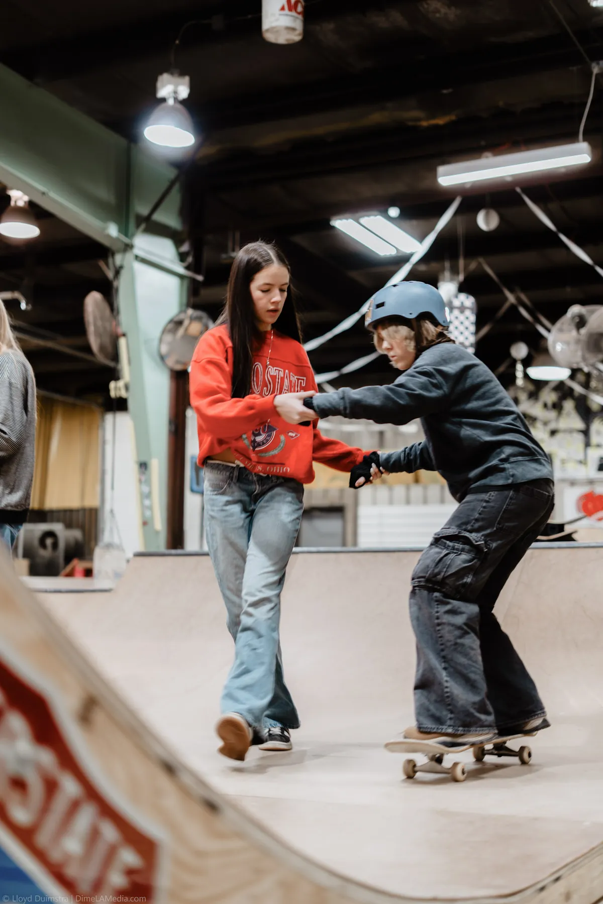 Skate coach cheering on a beginner indoors