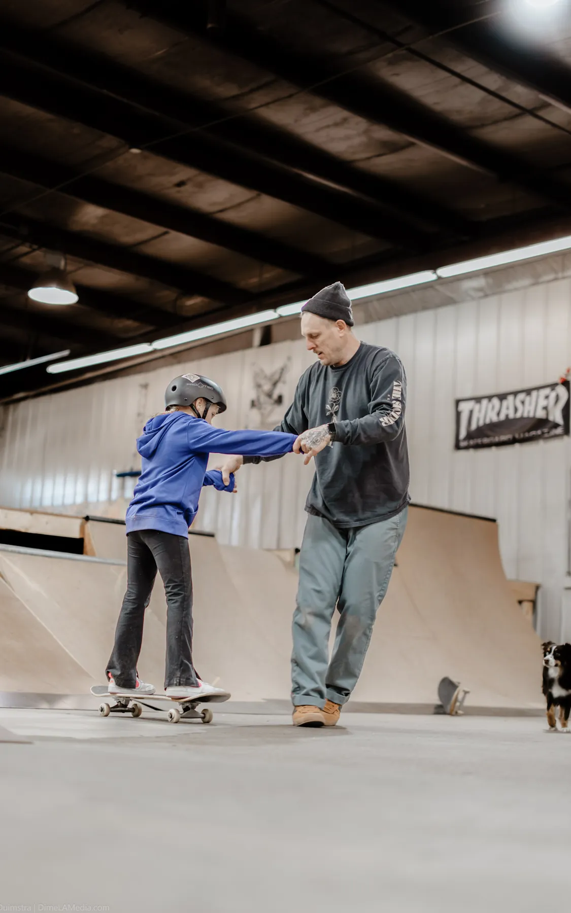 Patient coaching moment during an indoor skate lesson