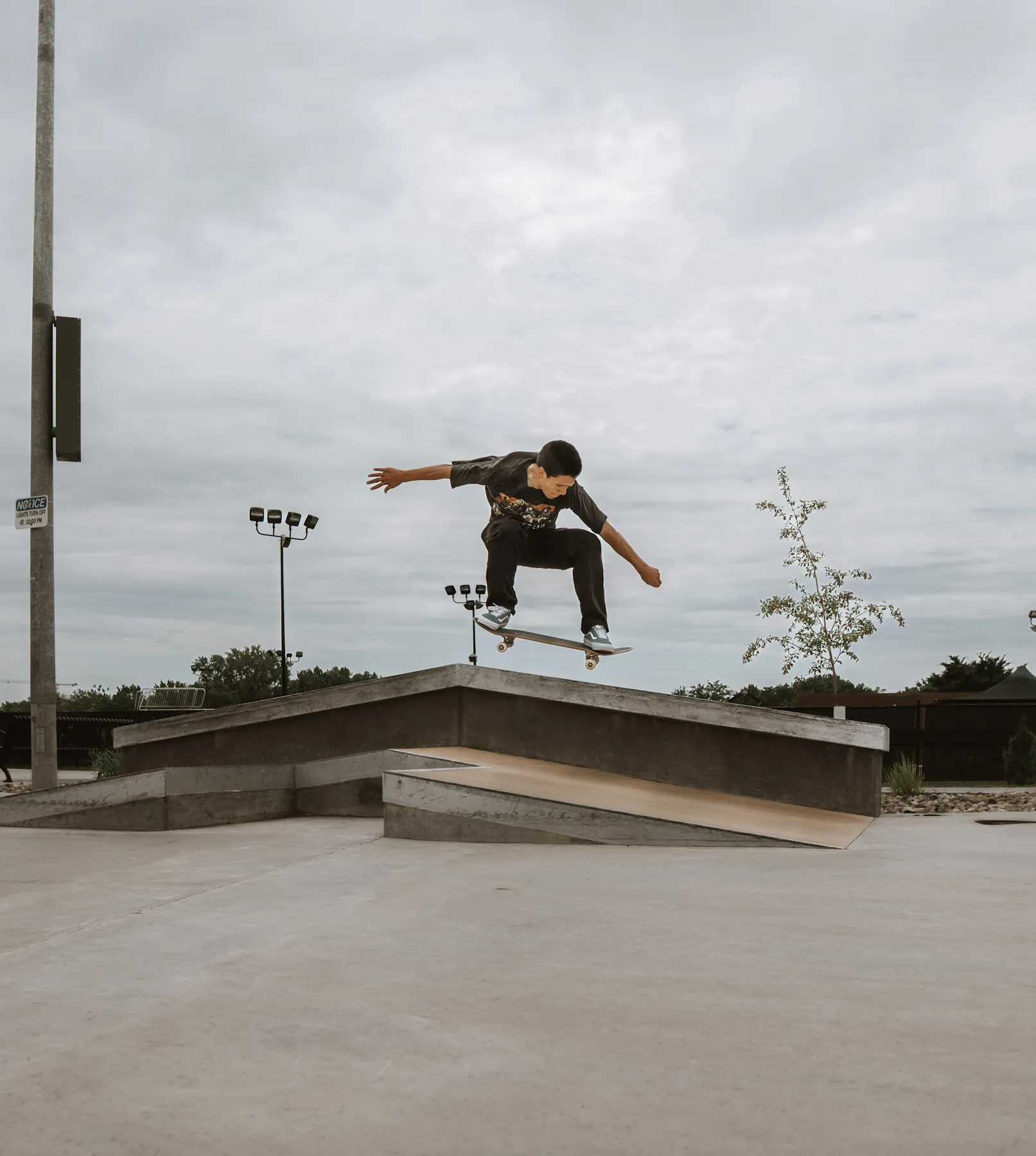 Skateboarder boosting off a ledge, Sioux Falls skatepark