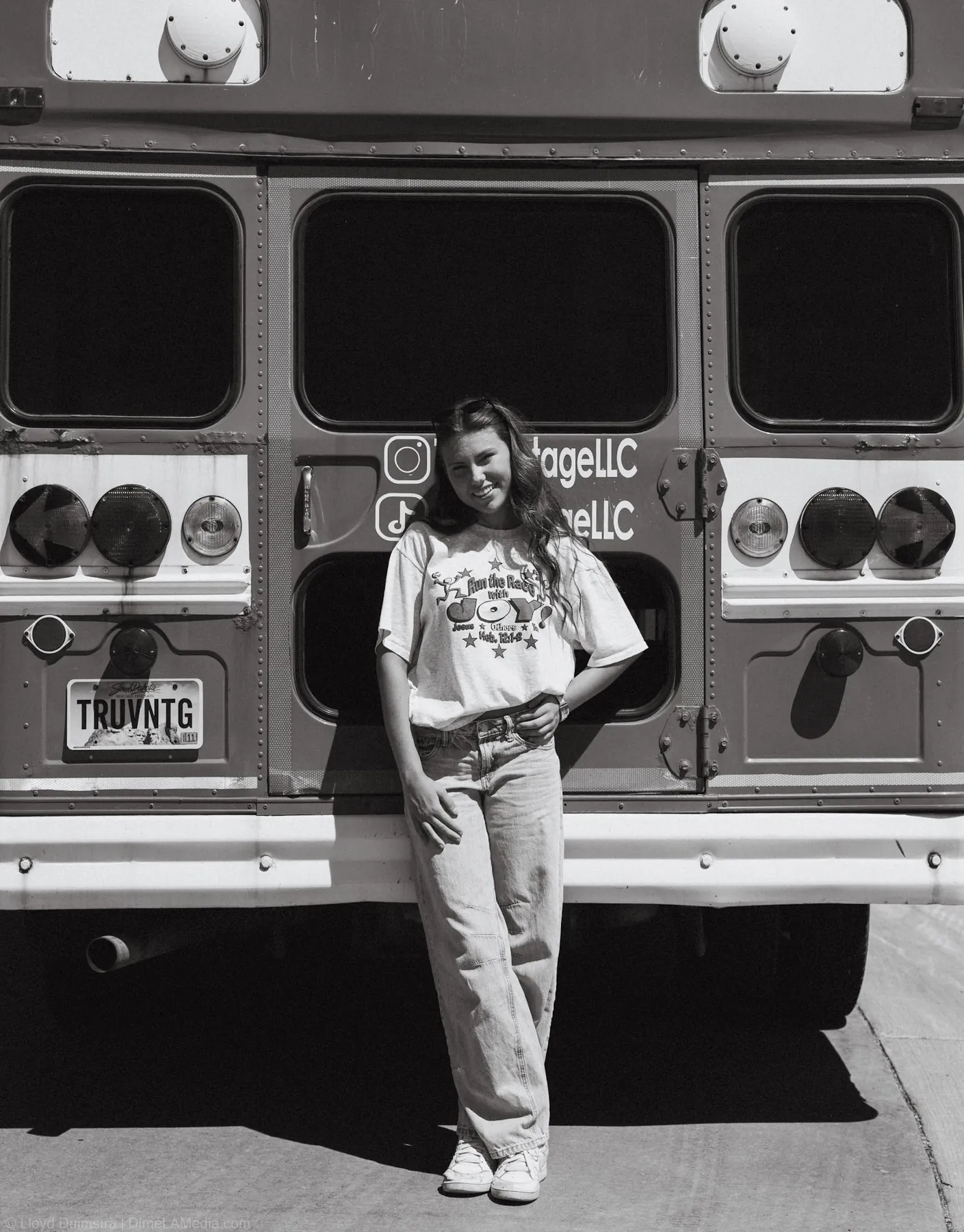 Black and white photo of Maddie at the back of the True Vintage bus