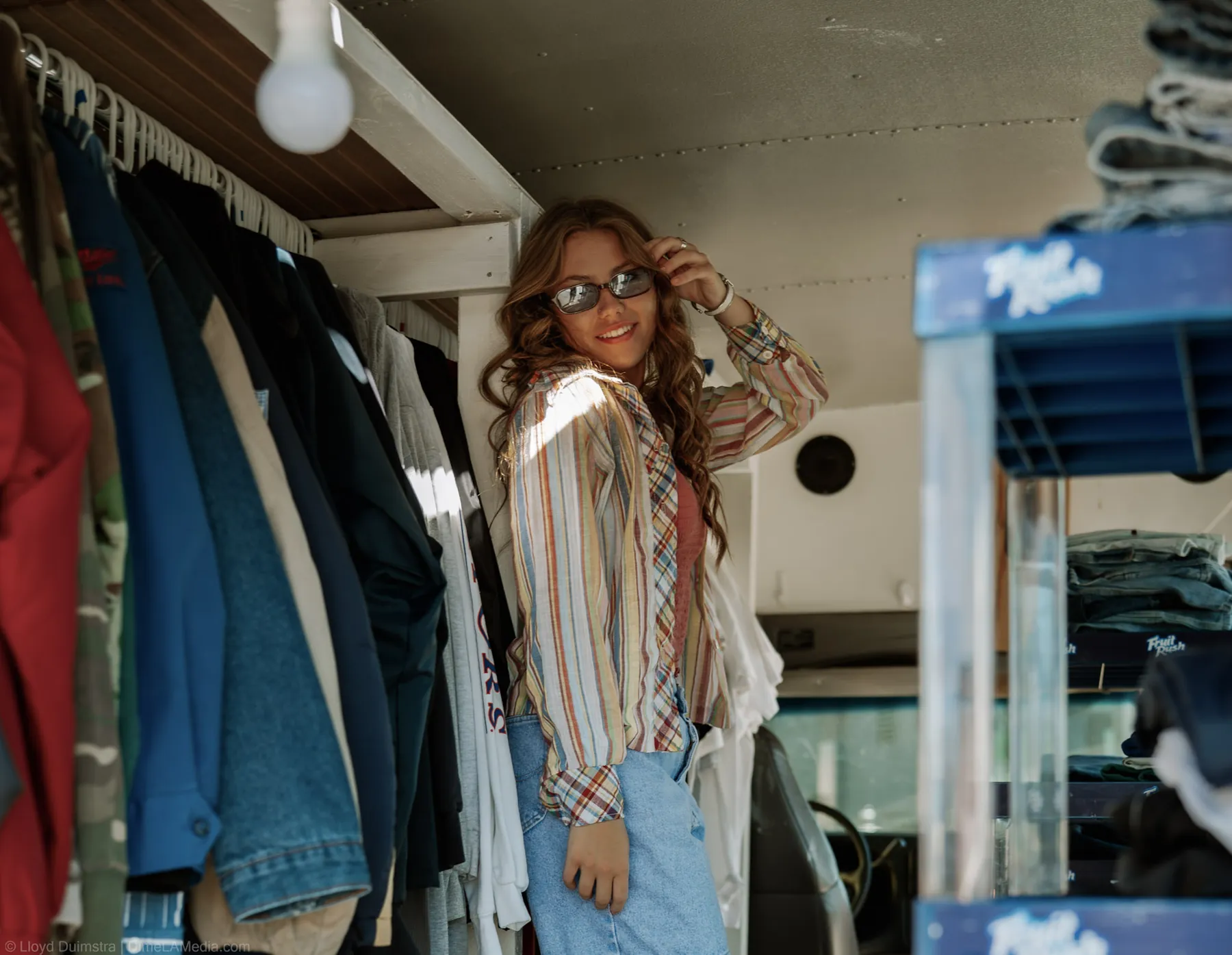 Vintage denim and jackets hanging inside the True Vintage bus