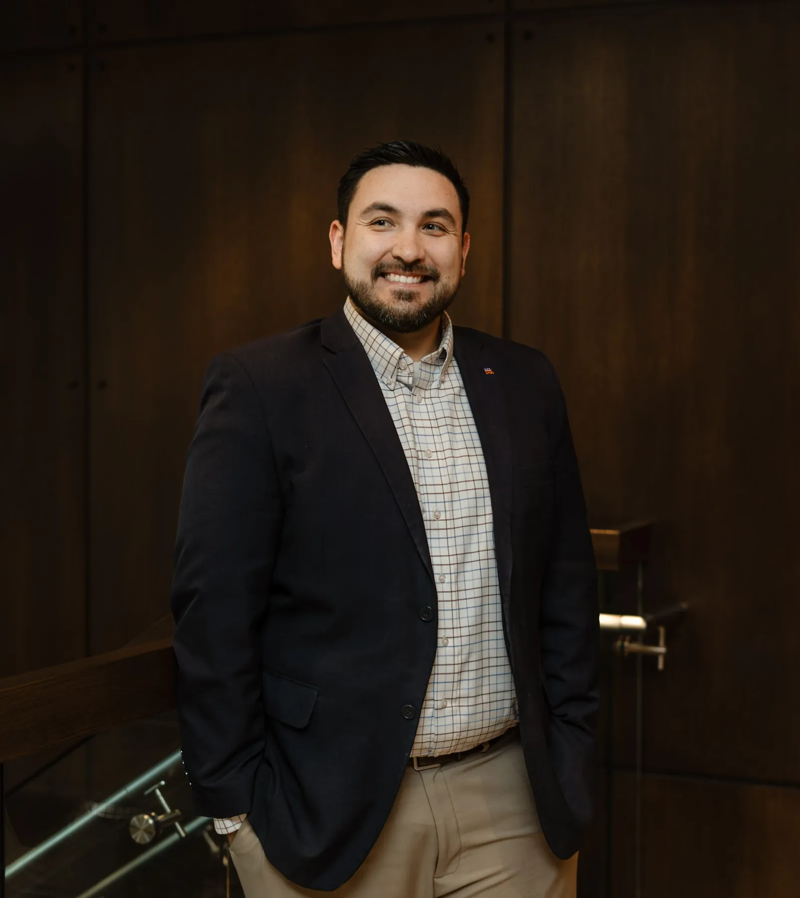 Tyler Tordsen portrait by a walnut office door, Sioux Falls business photography