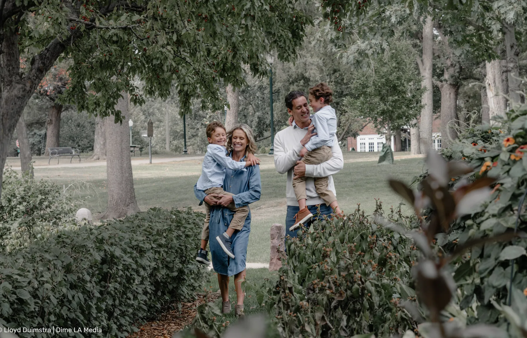 Mom scooping up both boys in the park