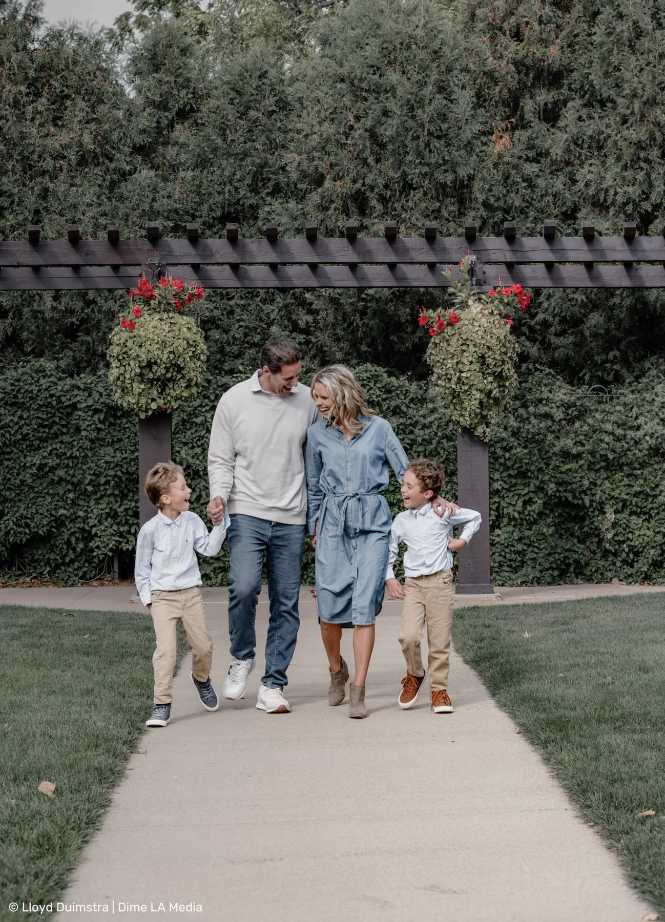 Mom and dad walking the garden path with their boys
