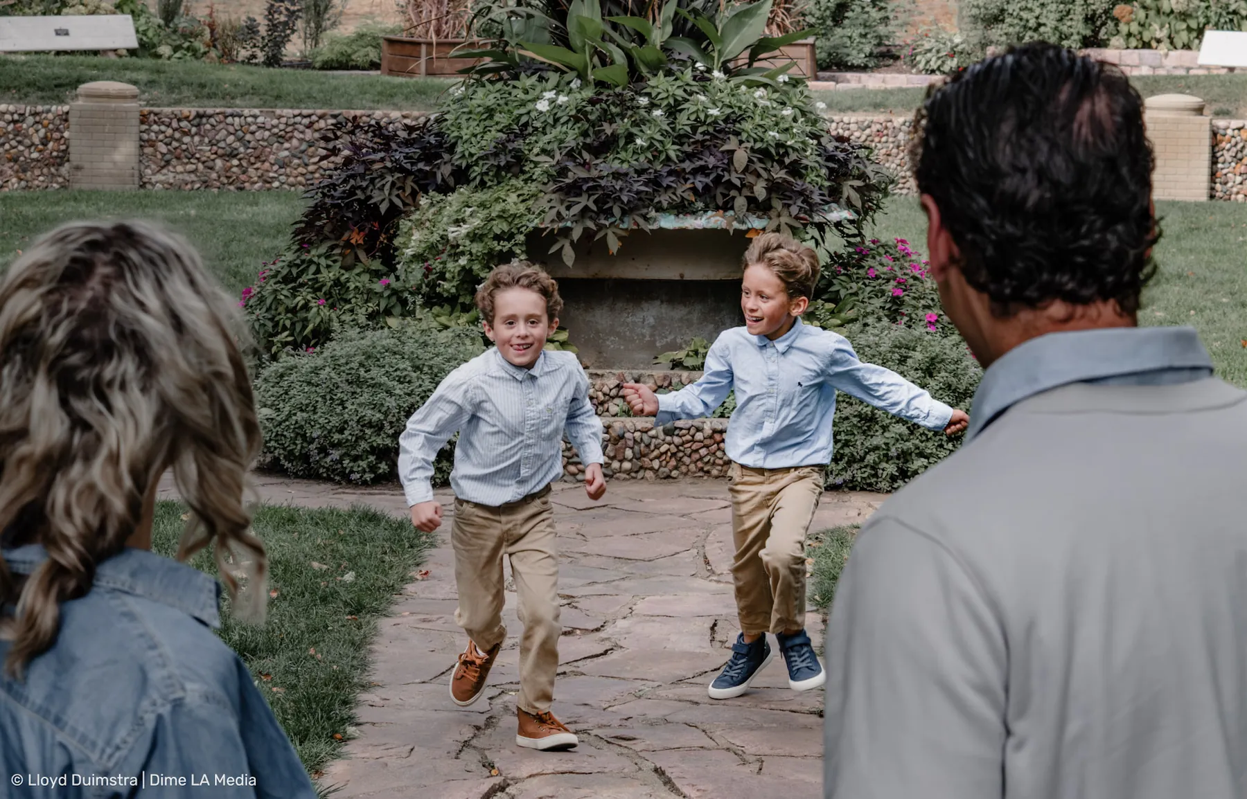 Brothers running through the garden during a family session