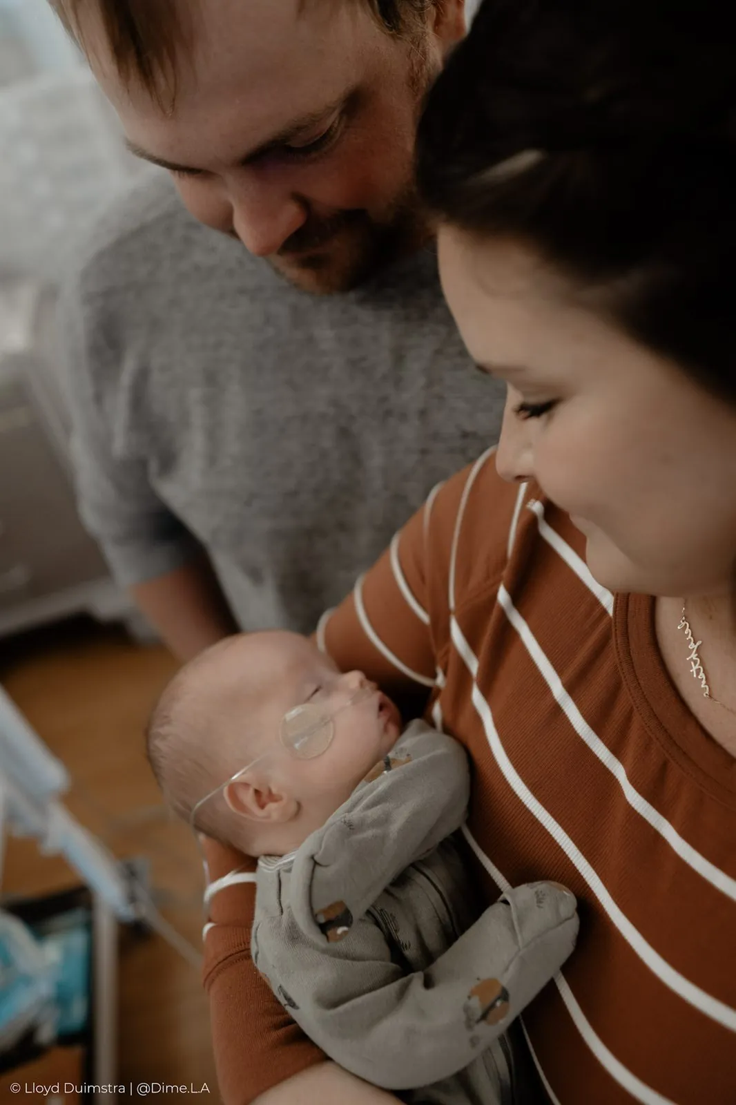 Parents gazing down at their newborn, Sioux Falls newborn photography