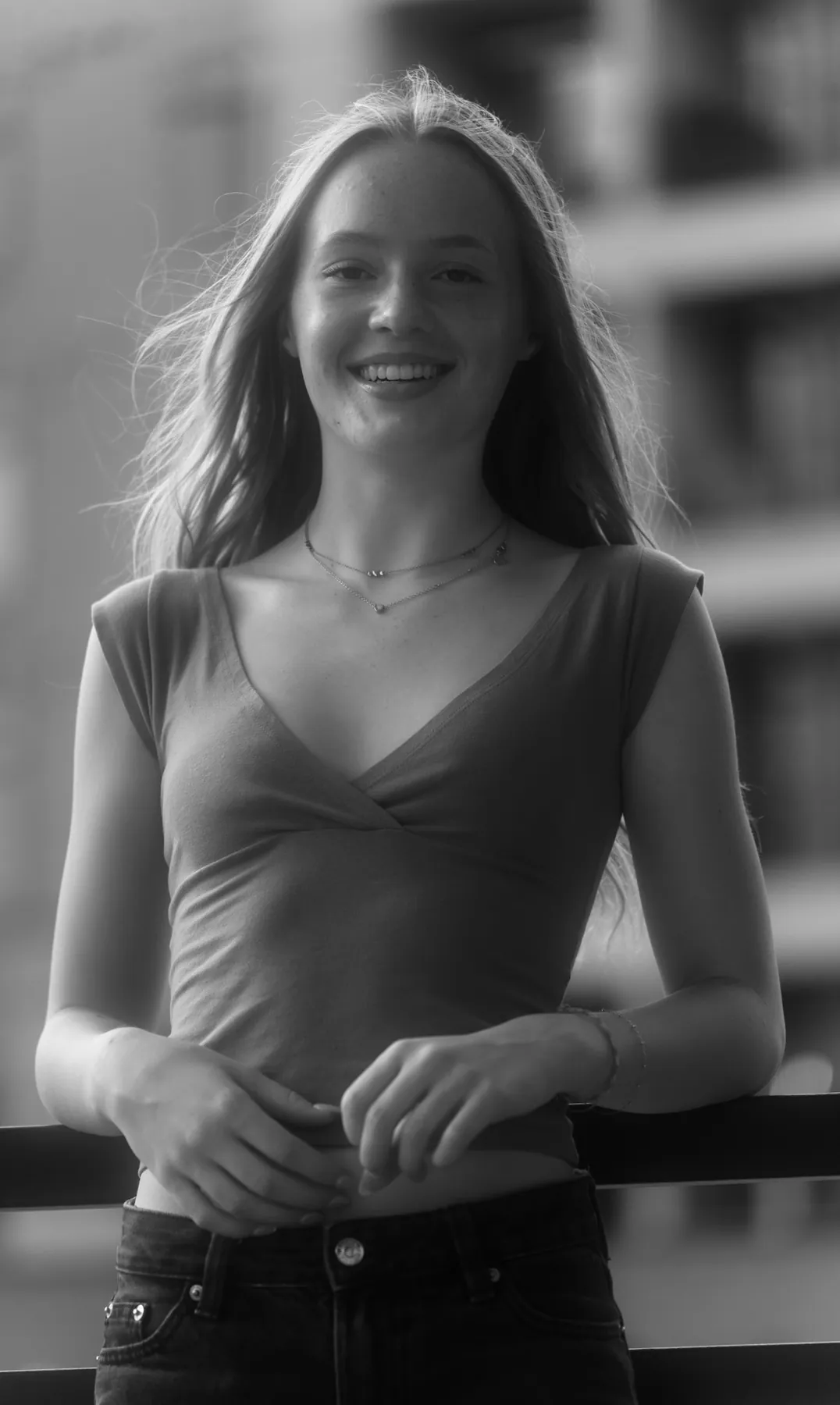 Black and white candid of a senior laughing in the wind