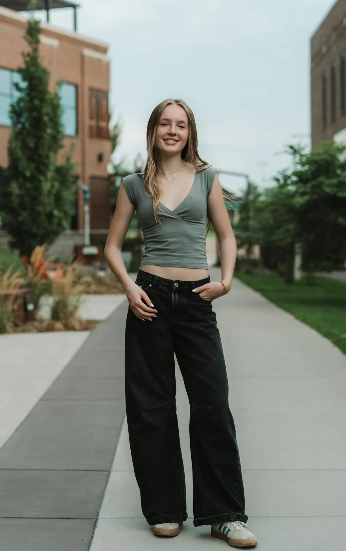 Full length senior portrait on a downtown Sioux Falls sidewalk