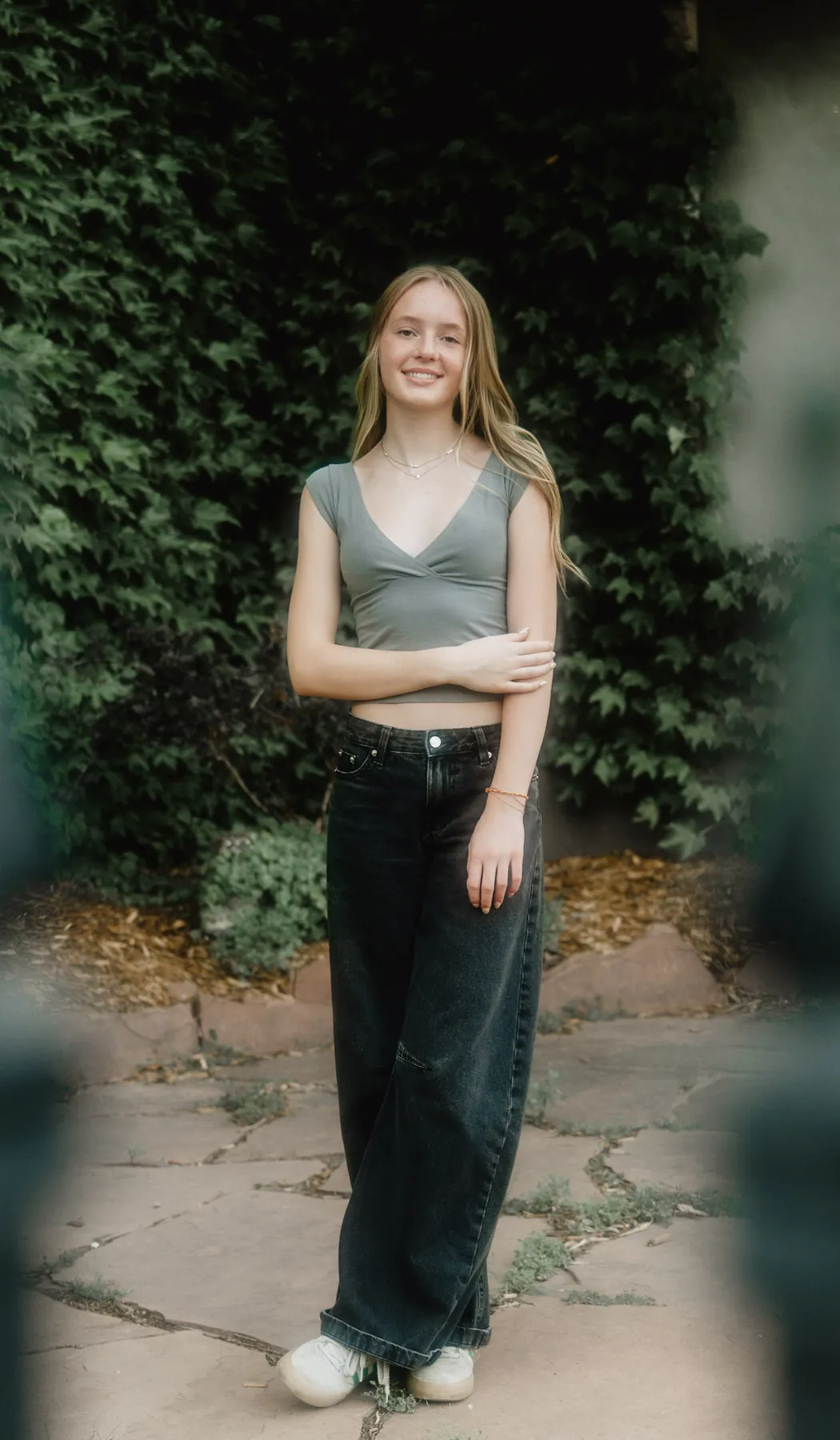 Full length senior portrait of Scout in front of a wall of ivy, Sioux Falls SD