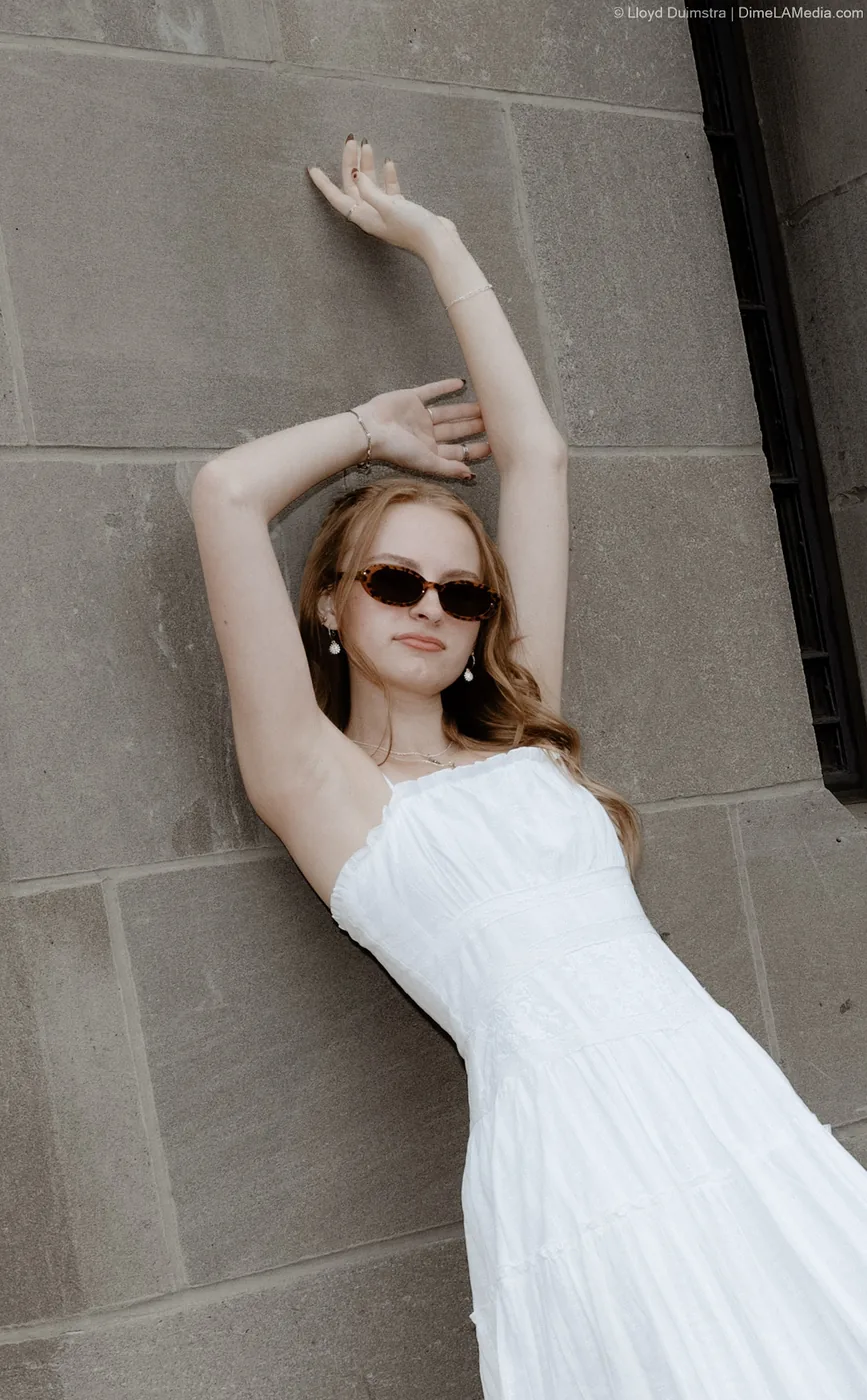 Syd Patzwald editorial senior portrait against a limestone wall, downtown Sioux Falls