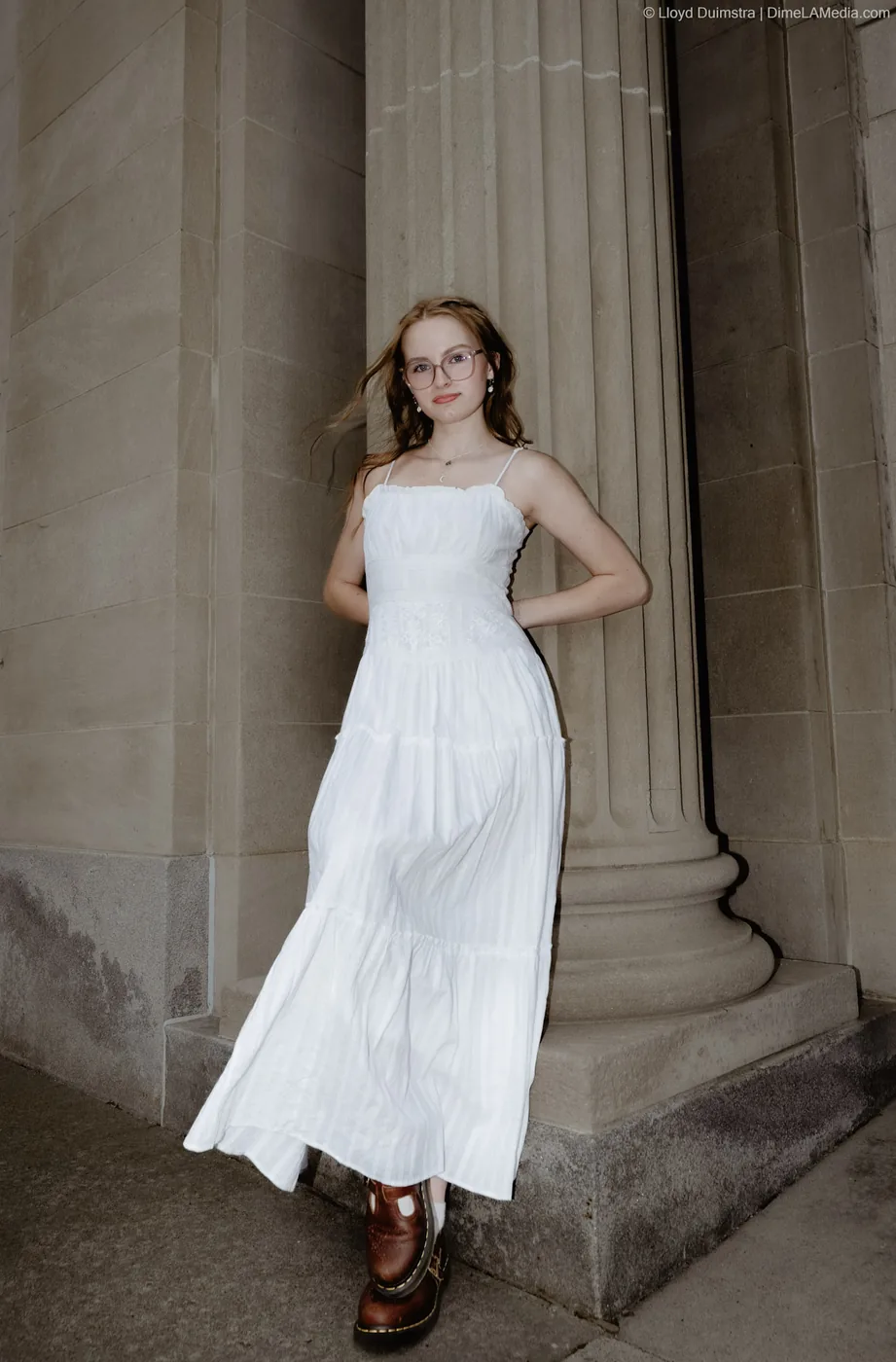 Syd Patzwald senior portrait by stone columns, downtown Sioux Falls