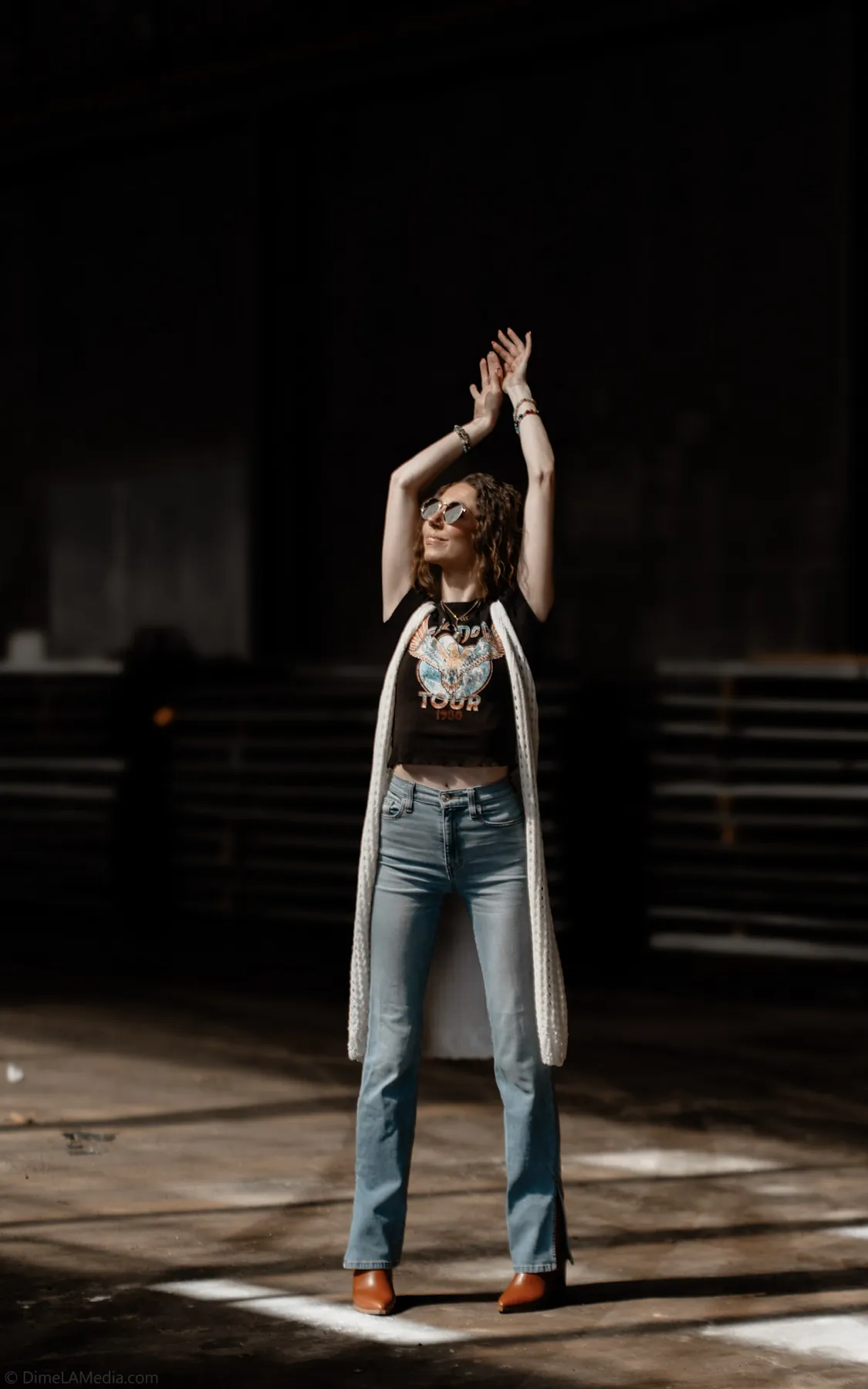Editorial portrait in a beam of light inside a warehouse