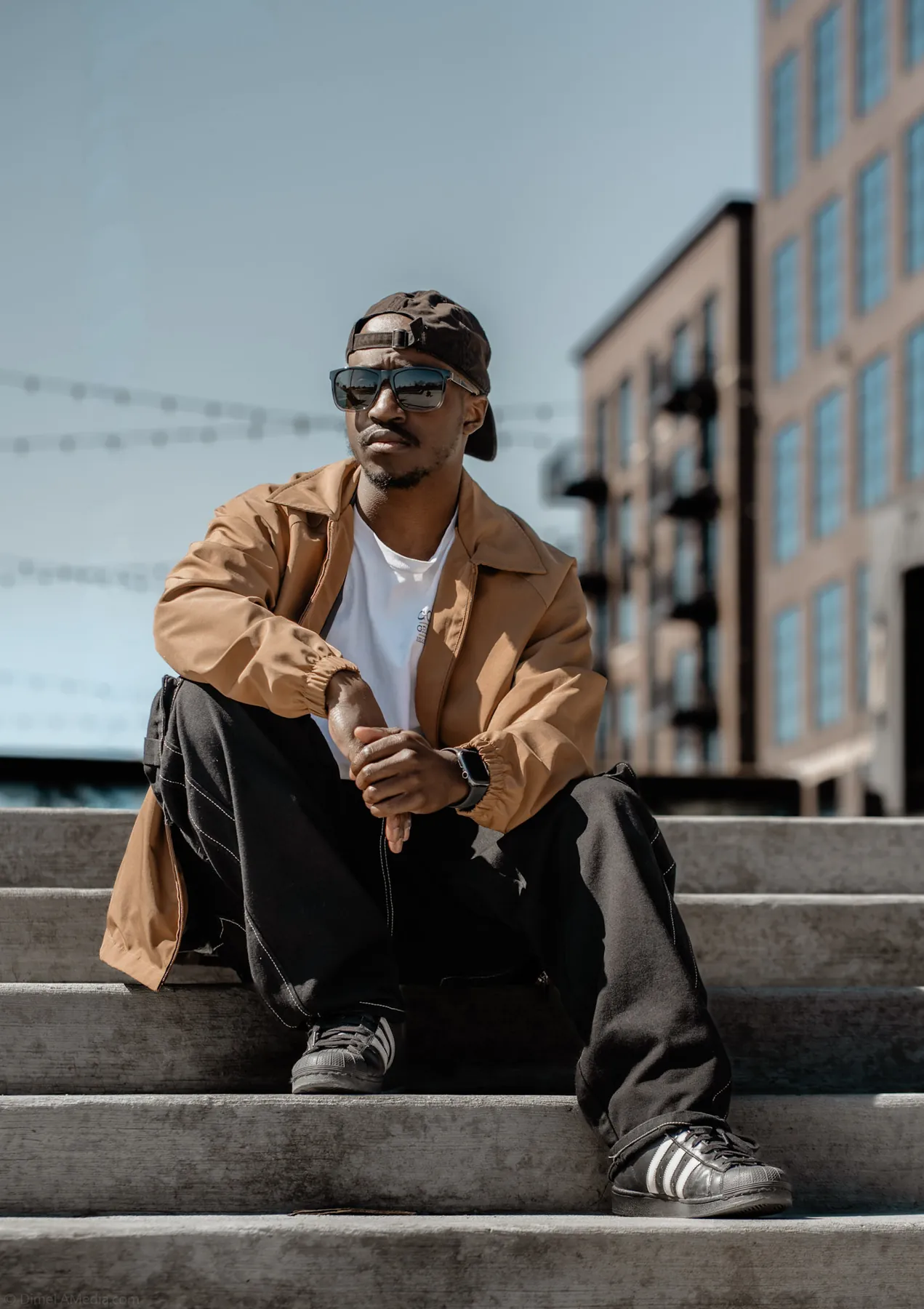 Street style portrait of a man seated on downtown steps, Sioux Falls SD