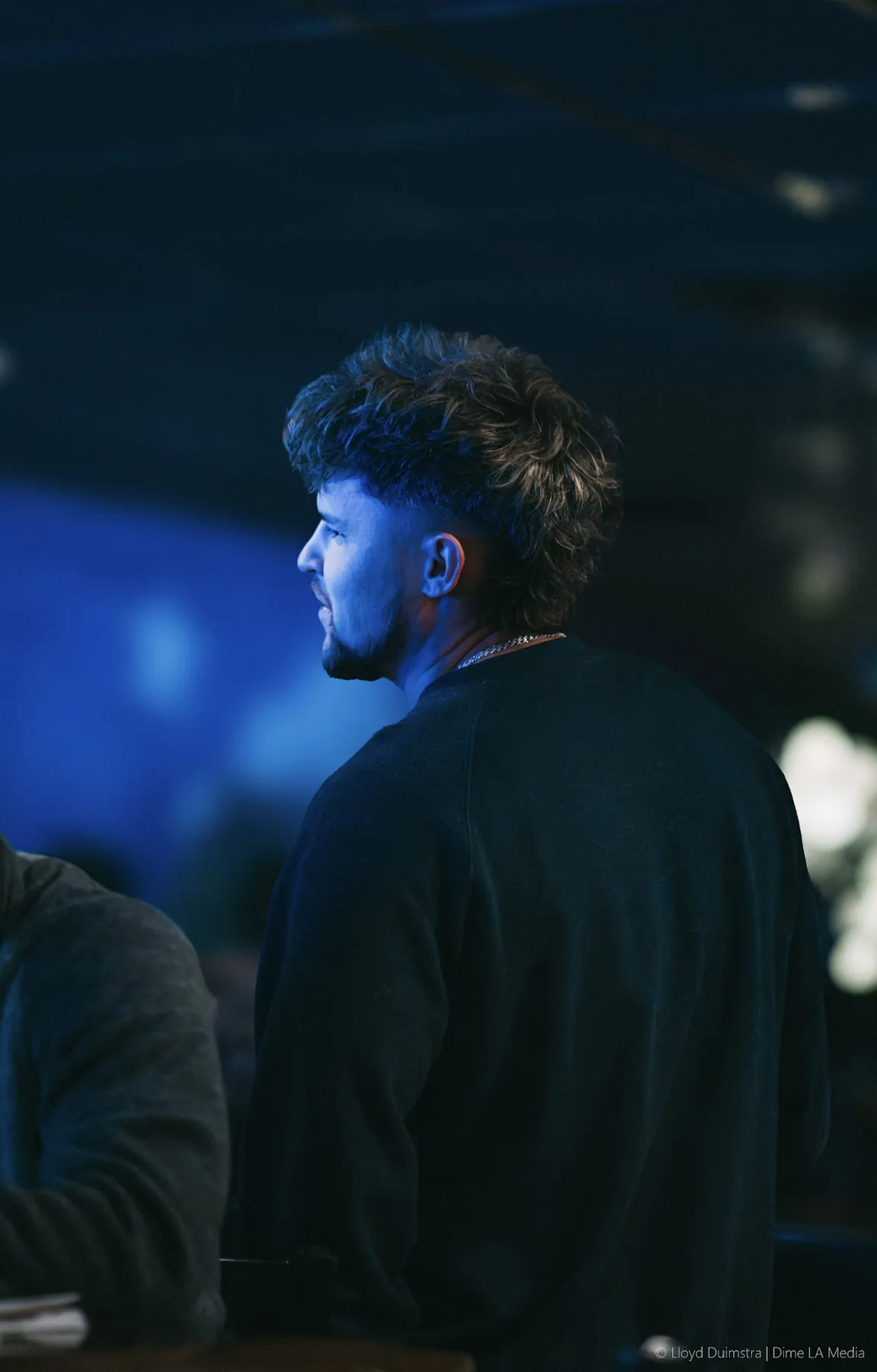 Moody blue-lit profile portrait at night