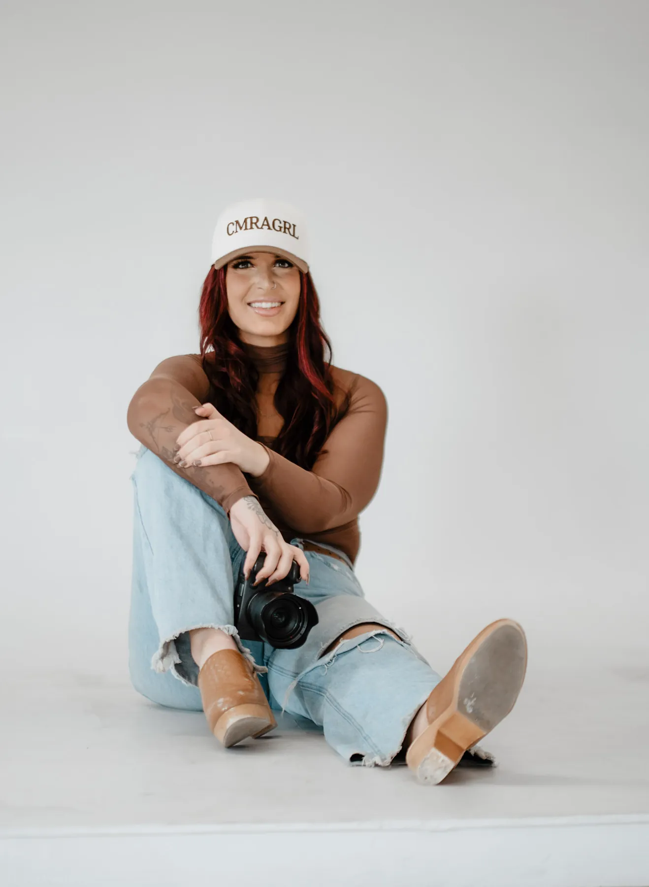 Personal branding portrait of a photographer seated with her camera in the studio, Sioux Falls SD