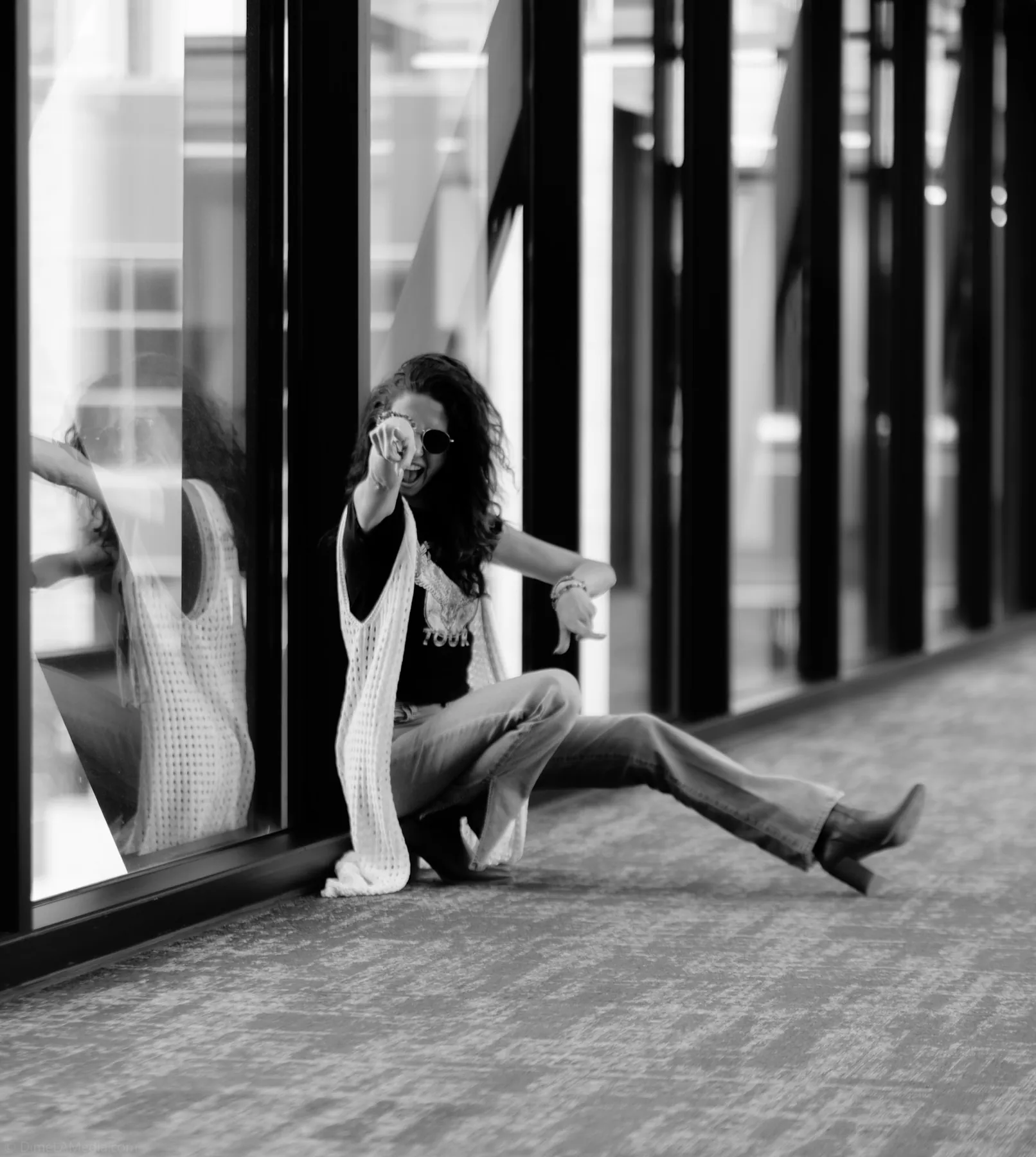 Black and white editorial portrait with window reflections