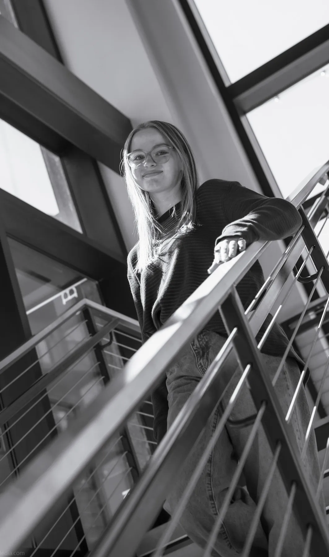 Black and white portrait of Syd Patzwald on a staircase landing