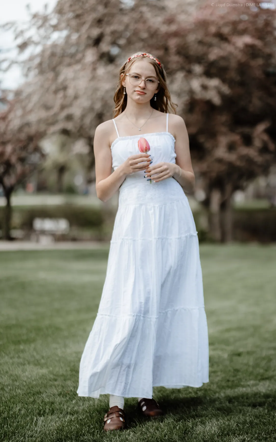 Syd Patzwald walking a park path in a light blue dress