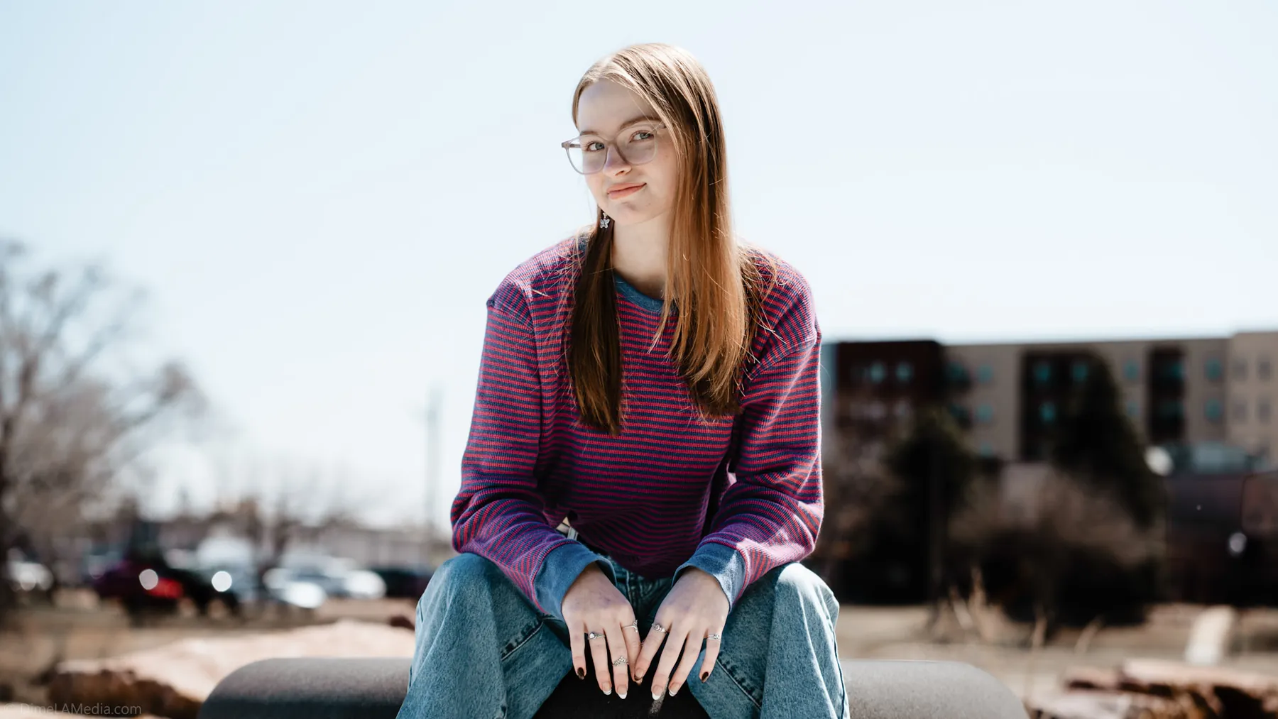 Syd Patzwald seated on a stone bench in downtown Sioux Falls