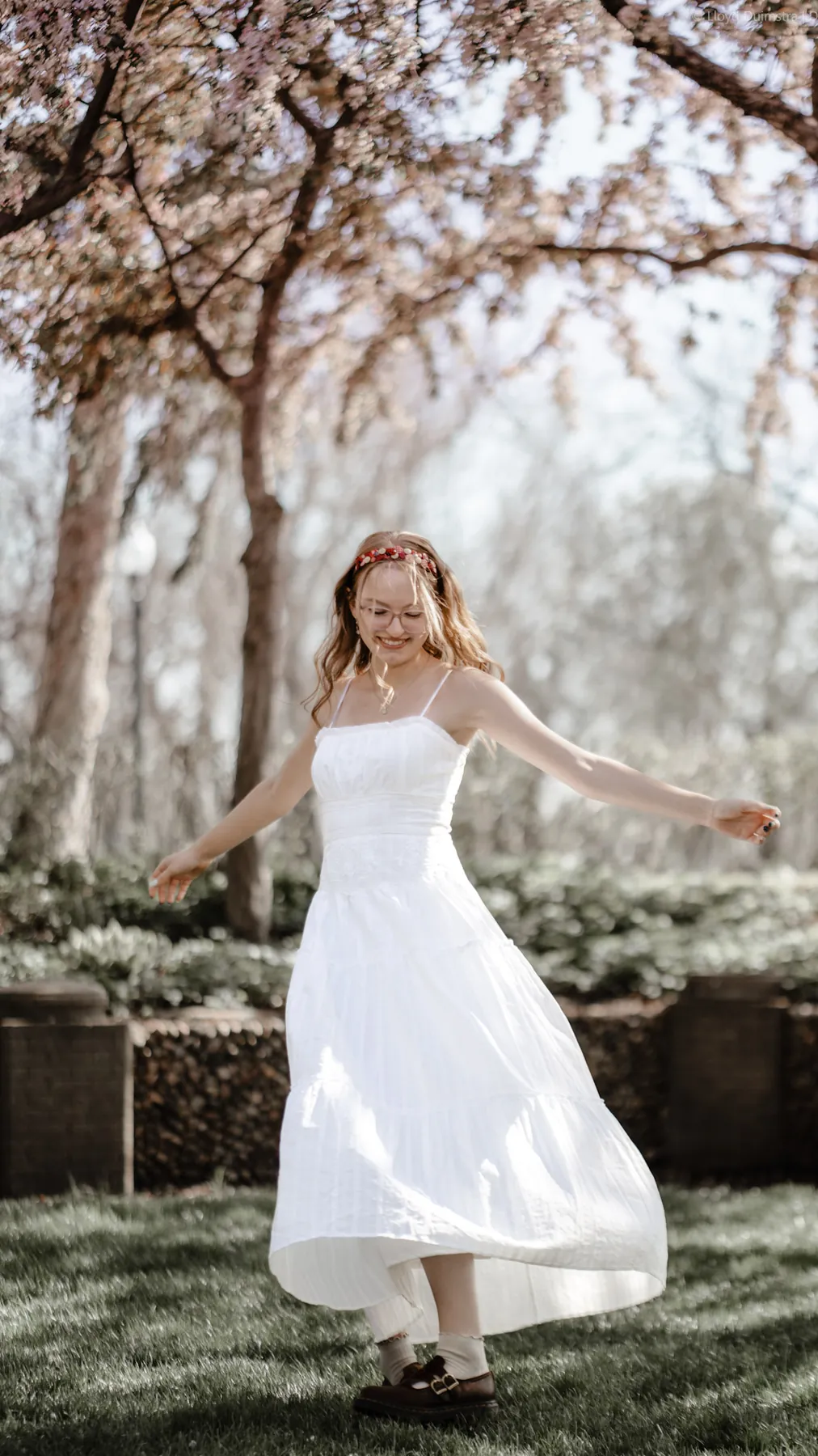 Syd Patzwald twirling a white dress in a Sioux Falls park